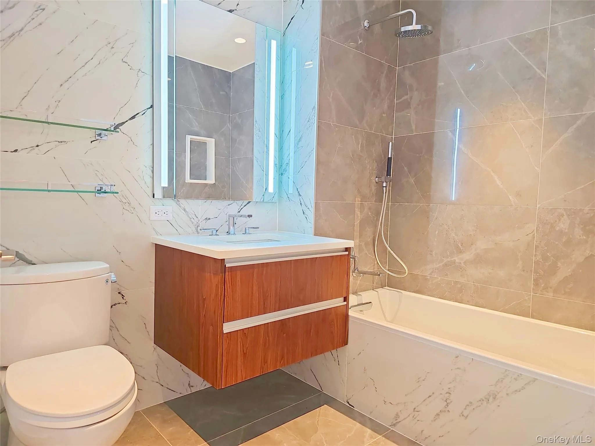 Full bath featuring tile walls, vanity, and shower / bathtub combination Full bath featuring tile walls, vanity, and shower / bathtub combination