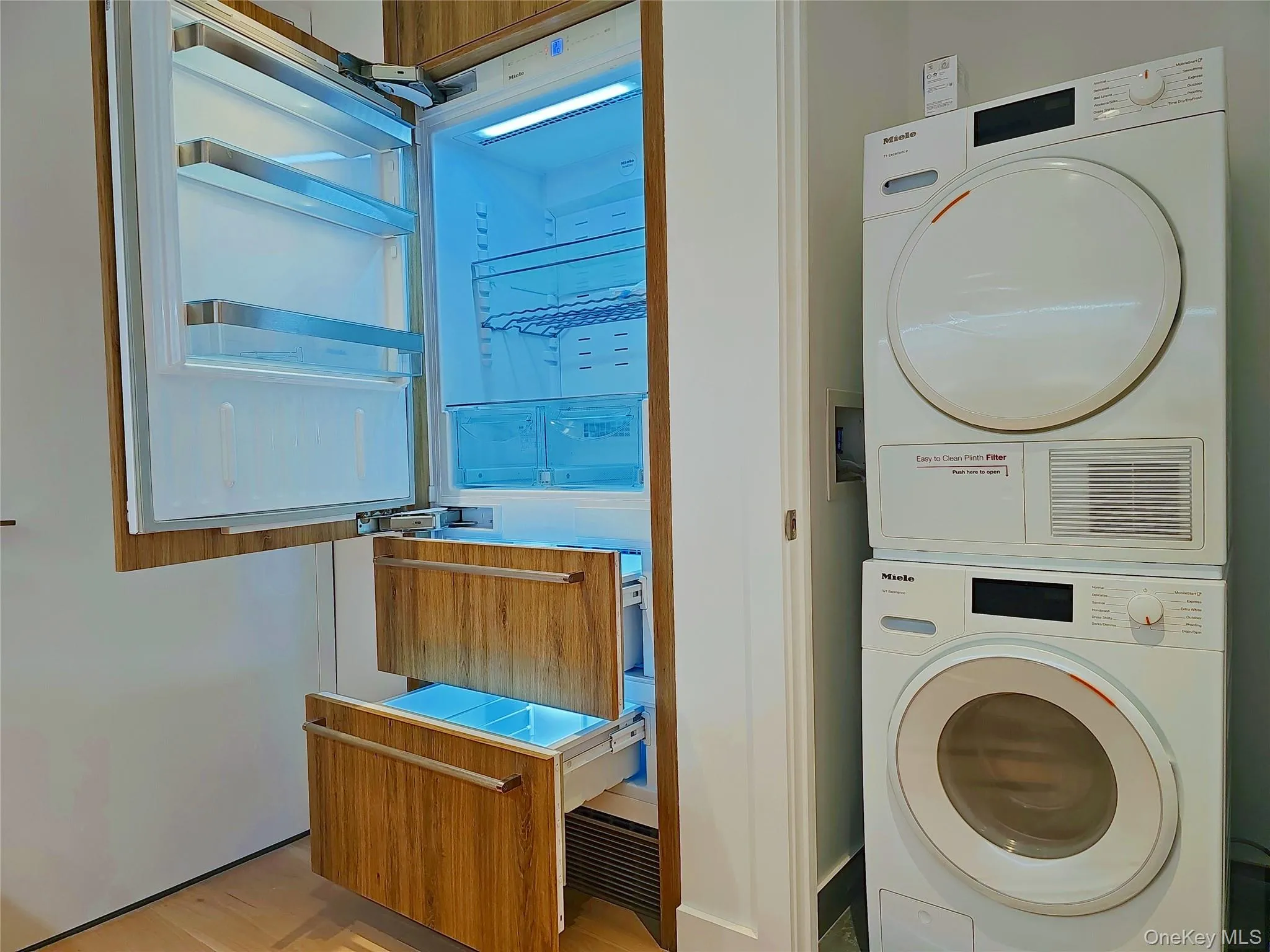 Laundry area with stacked washing machine and dryer Laundry area with stacked washing machine and dryer