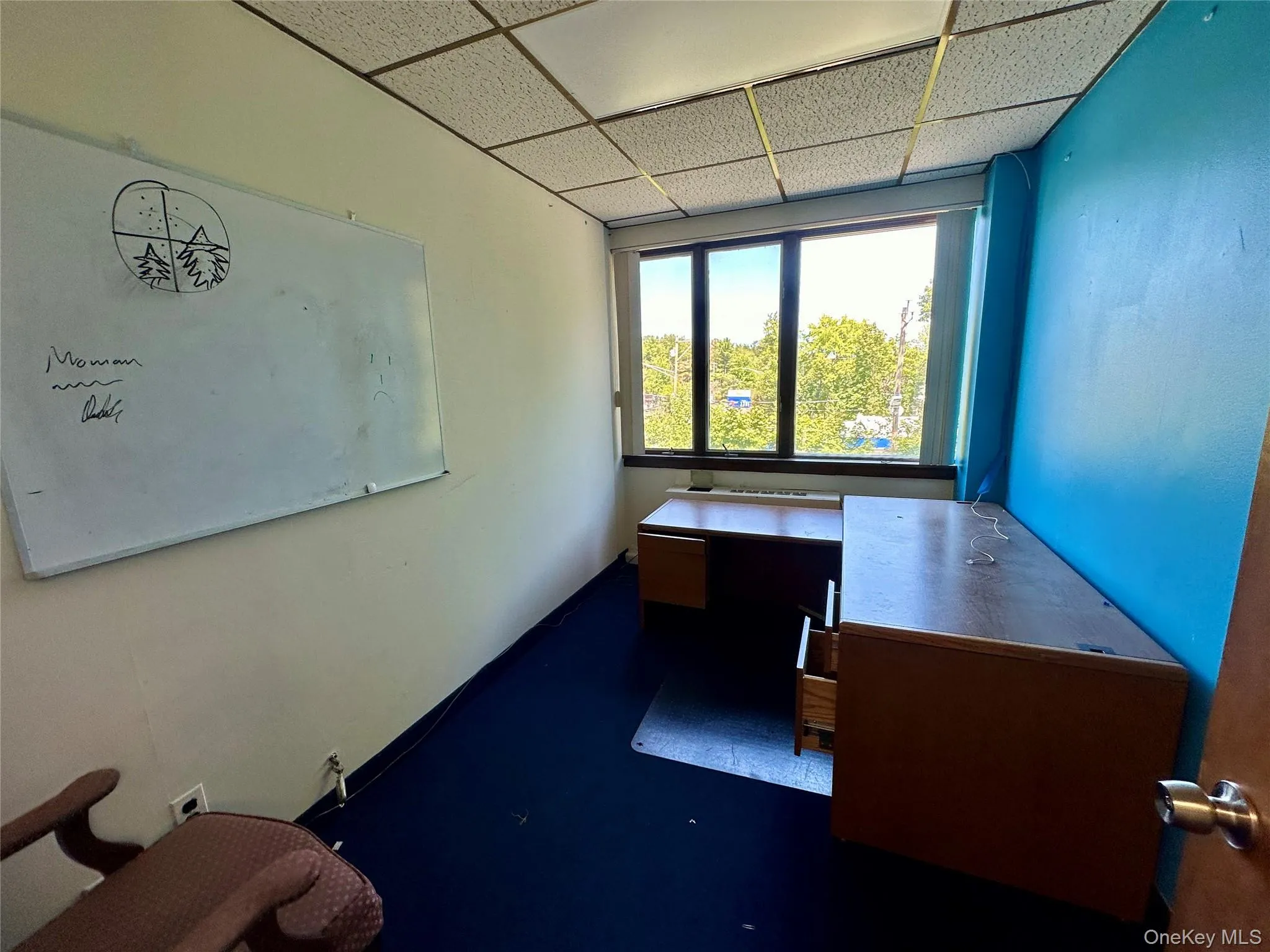 Unfurnished office with a drop ceiling Unfurnished office with a drop ceiling