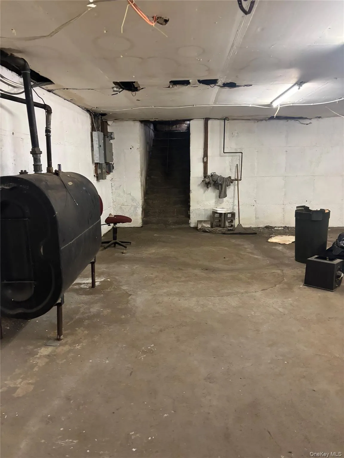 Unfinished basement featuring oil tank Unfinished basement featuring oil tank