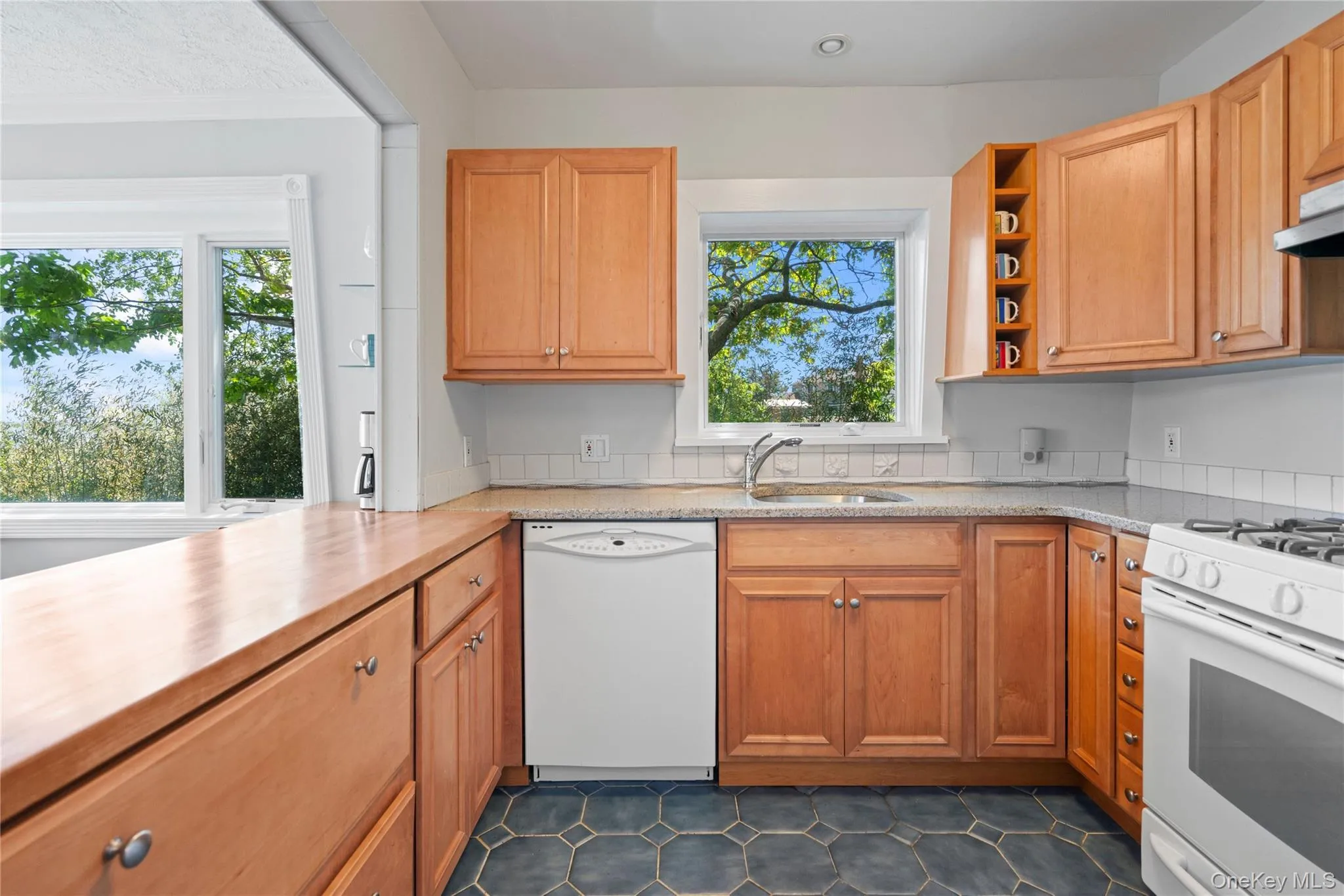 Kitchen with white appliances, open shelves, plenty of natural light, and brown cabinets Kitchen with white appliances, open shelves, plenty of natural light, and brown cabinets
