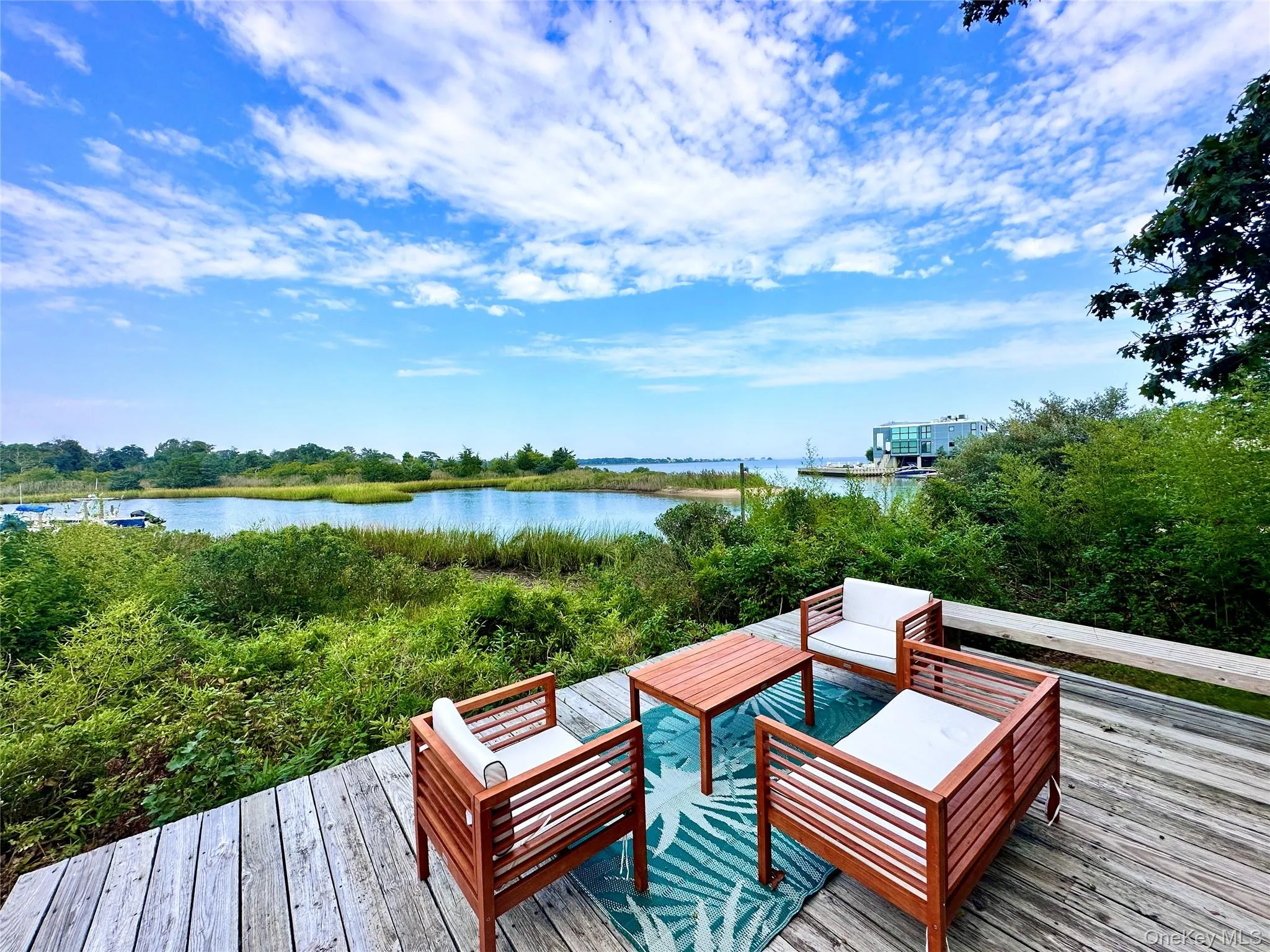 Wooden terrace featuring a water view Wooden terrace featuring a water view
