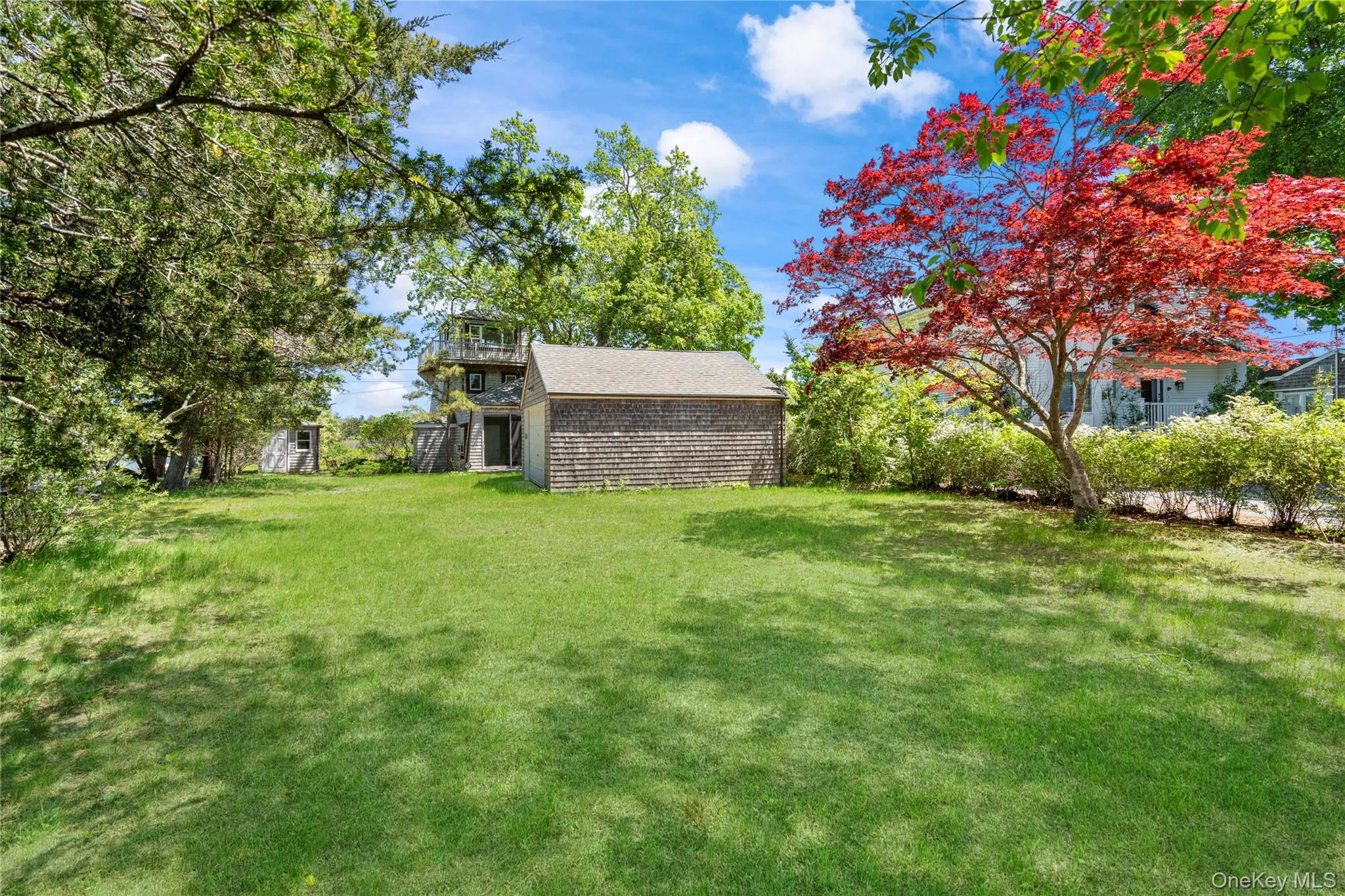 View of grassy yard with a balcony View of grassy yard with a balcony