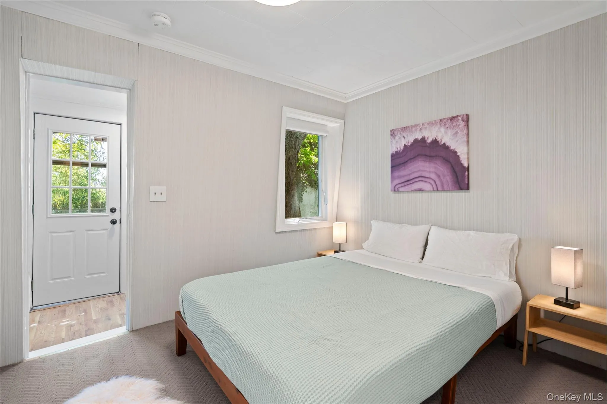 Bedroom featuring crown molding and carpet flooring Bedroom featuring crown molding and carpet flooring