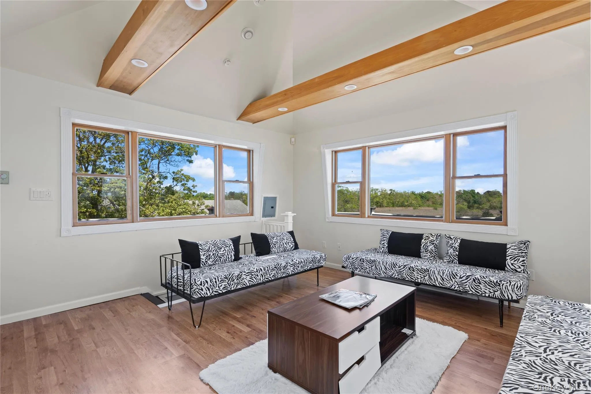 Living area featuring wood finished floors and baseboards Living area featuring wood finished floors and baseboards