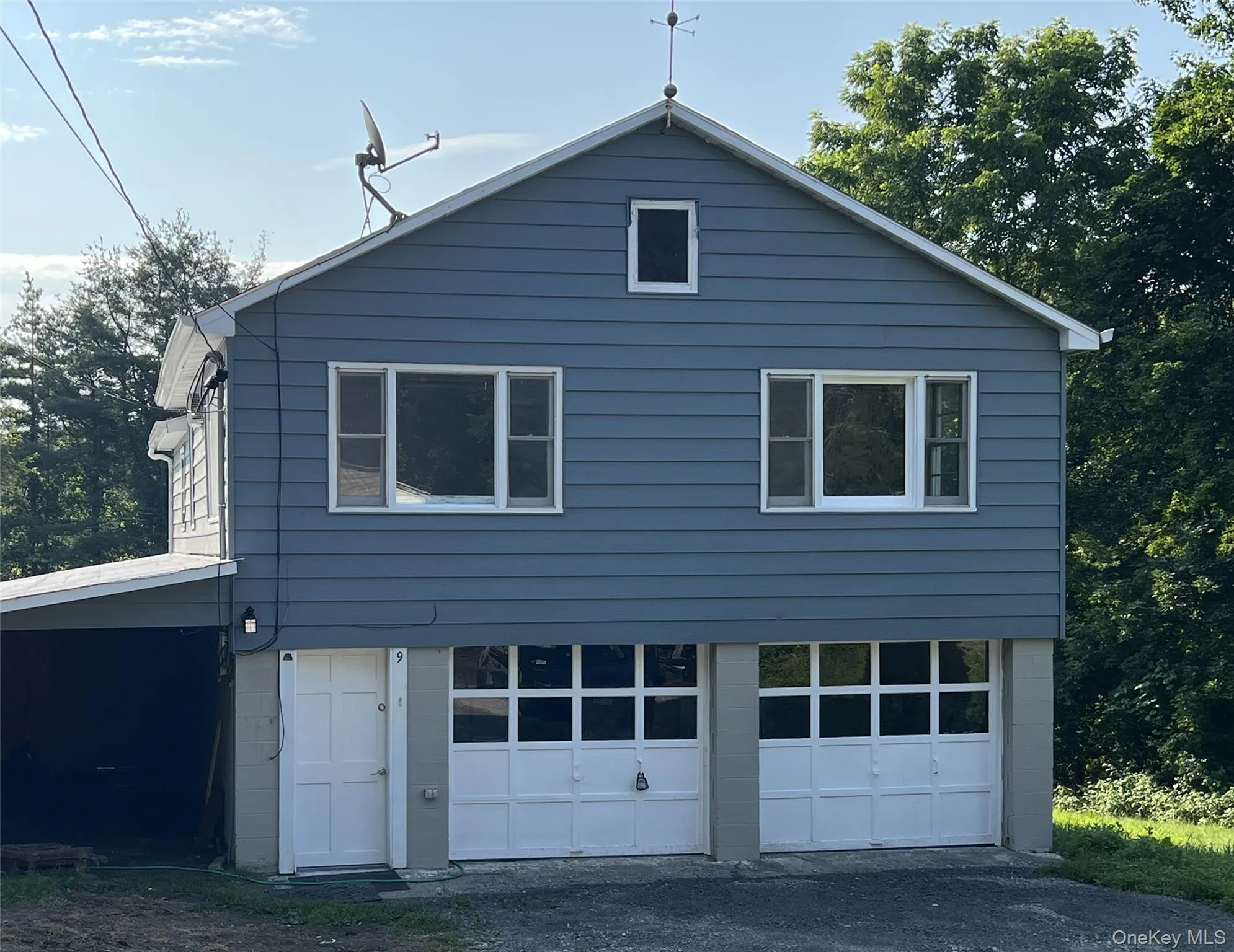 View of side of home with a garage View of side of home with a garage
