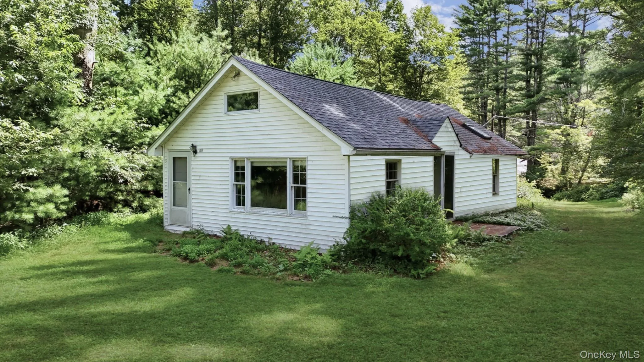View of guest house exterior featuring a very large lawn View of guest house exterior featuring a very large lawn