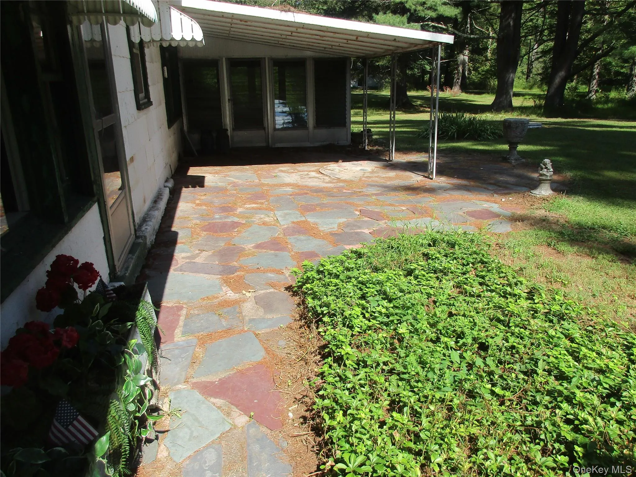 View of patio featuring a sunroom View of patio featuring a sunroom