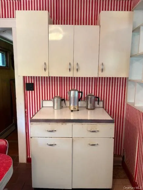 Kitchen vintage cabinets, sink on right, many shelves. Kitchen vintage cabinets, sink on right, many shelves.