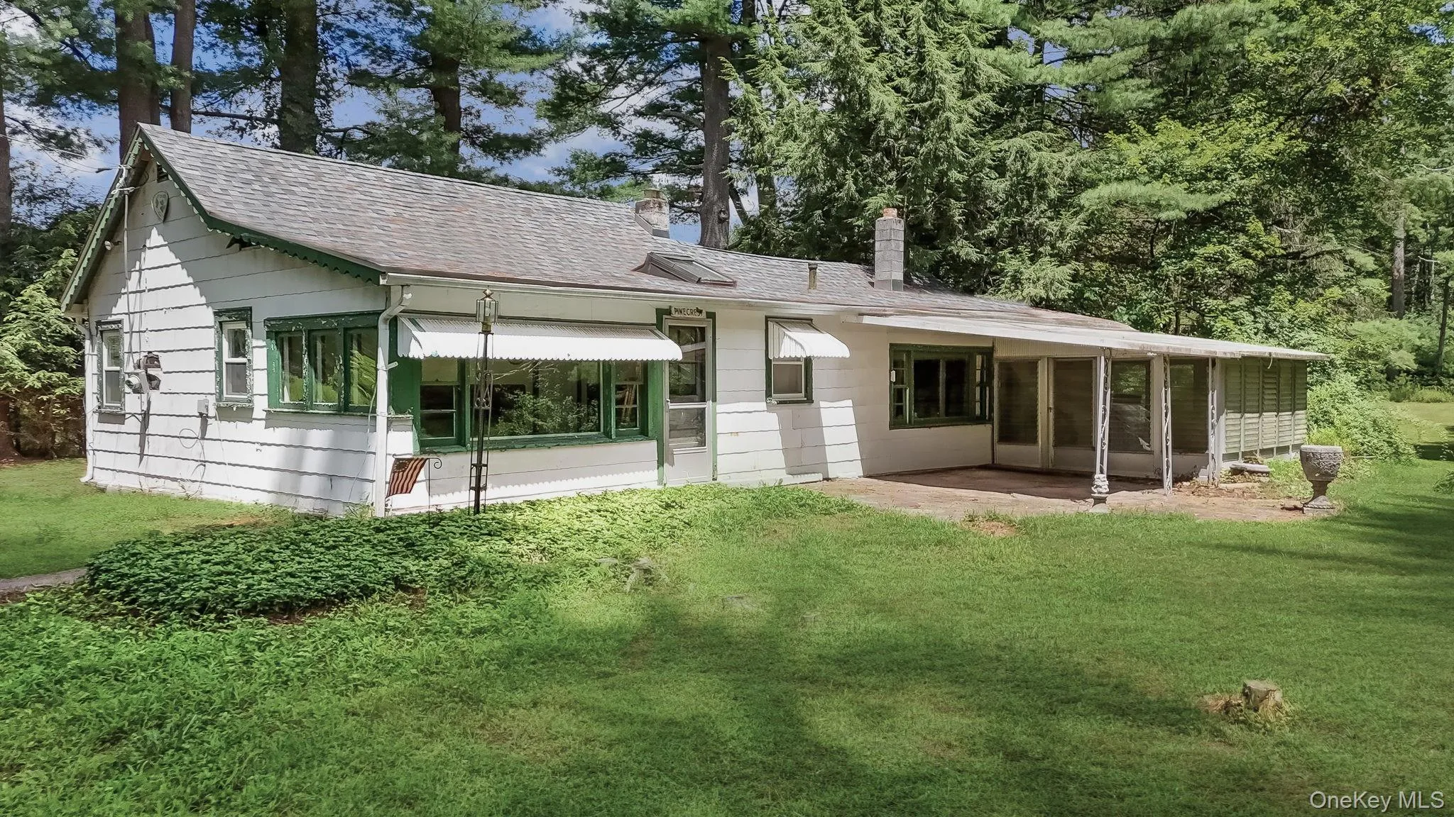 Main House used as a Front entrance of with a sunroom, a yard, enclosed porch, and patio. Main House used as a Front entrance of with a sunroom, a yard, enclosed porch, and patio.