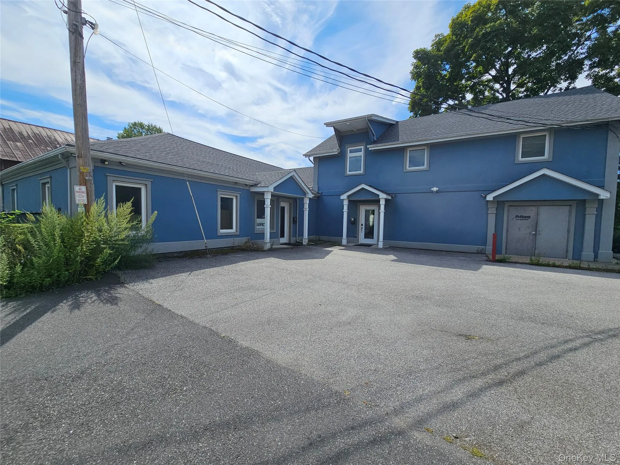 Traditional home featuring stucco siding and roof with shingles Traditional home featuring stucco siding and roof with shingles