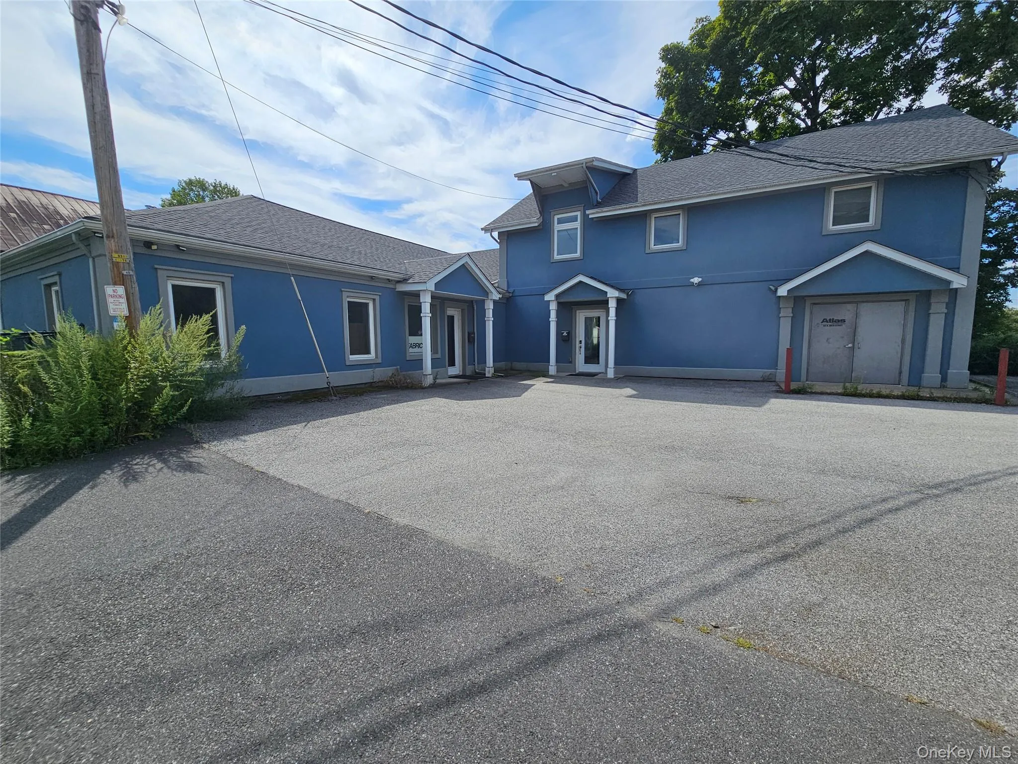 Traditional home featuring stucco siding and roof with shingles Traditional home featuring stucco siding and roof with shingles