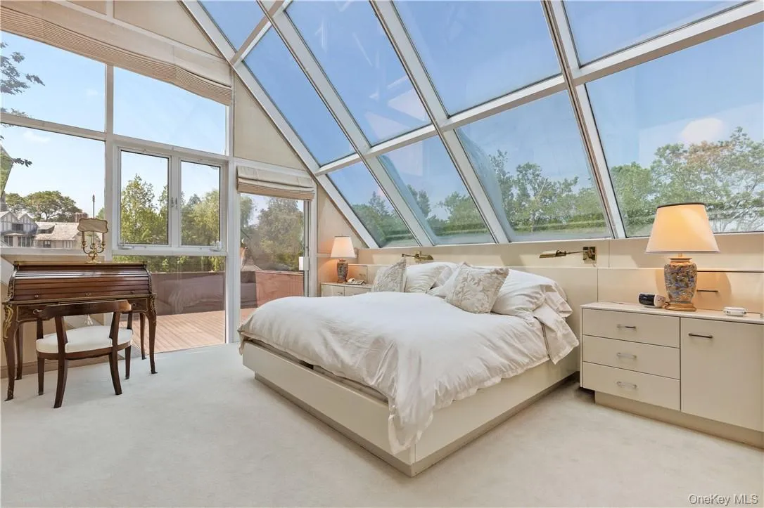 Primary Suite Bedroom with Access to Balcony Overlooking the Property Primary Suite Bedroom with Access to Balcony Overlooking the Property