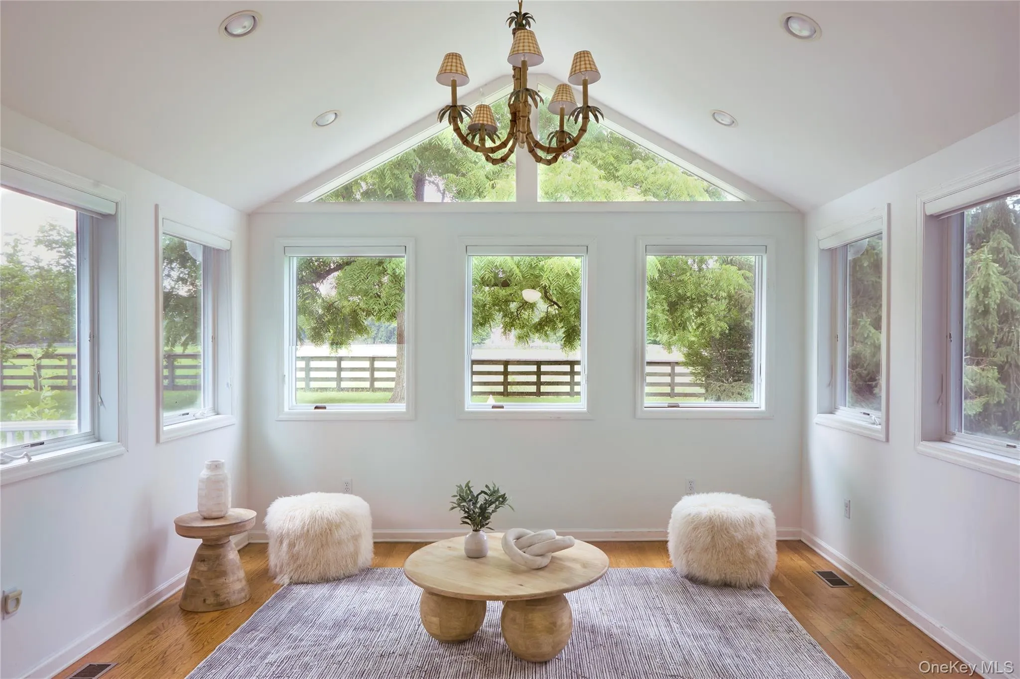 Sunroom featuring a chandelier and vaulted ceiling Sunroom featuring a chandelier and vaulted ceiling
