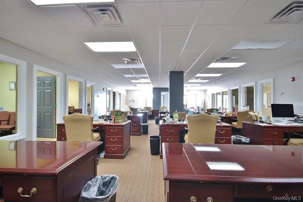 Office area with a drop ceiling and light colored carpet Office area with a drop ceiling and light colored carpet