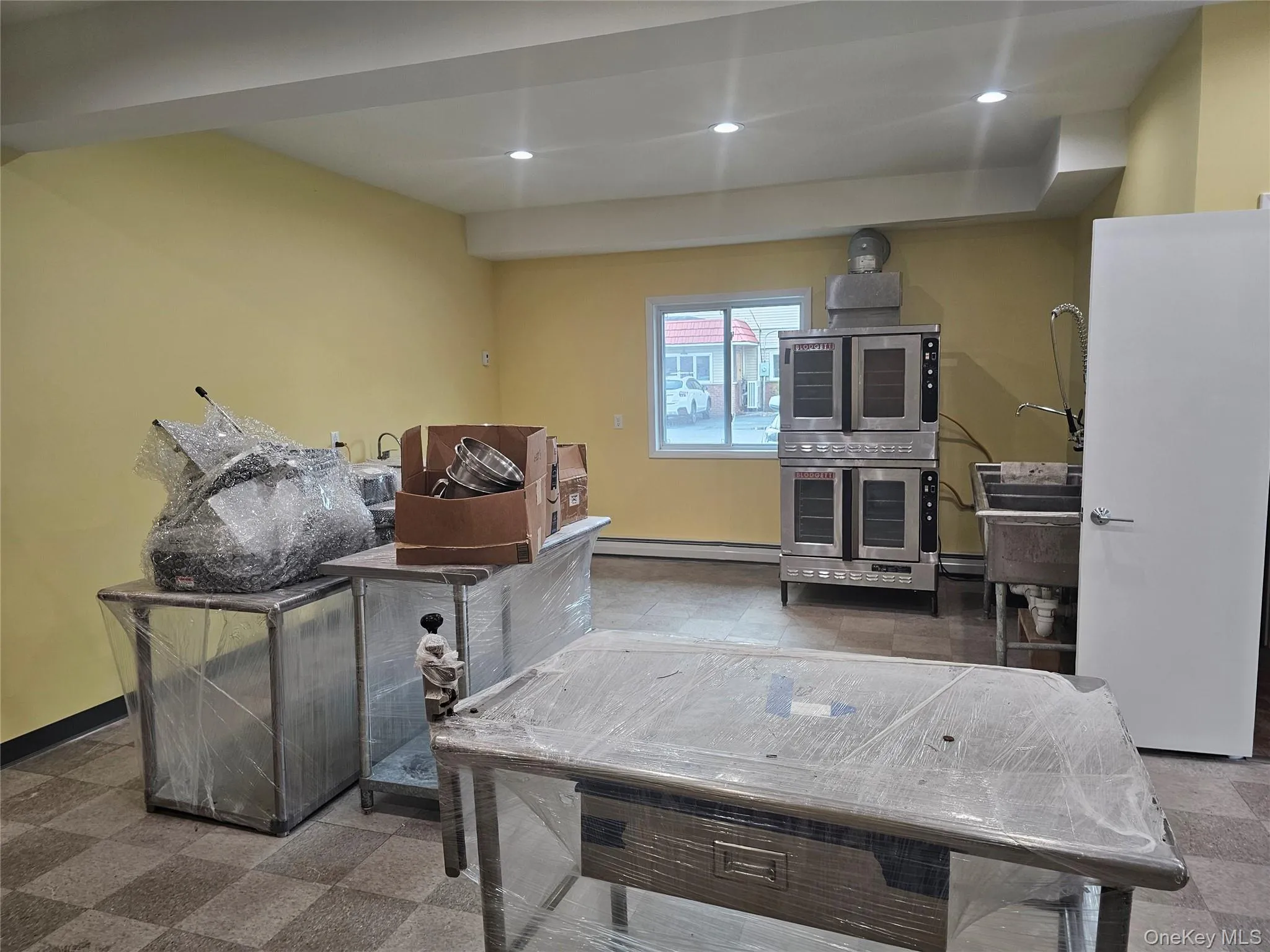 Rec room featuring recessed lighting and a baseboard heating unit Rec room featuring recessed lighting and a baseboard heating unit