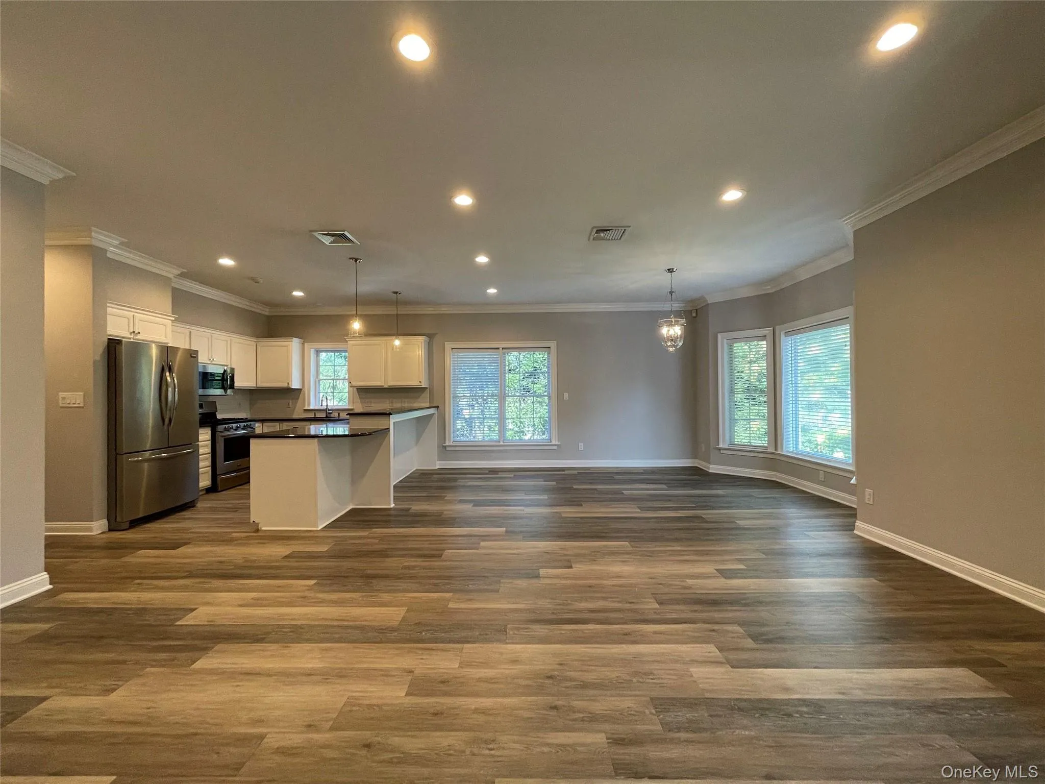 Open floor plan, crown molding, and recessed lighting Open floor plan, crown molding, and recessed lighting