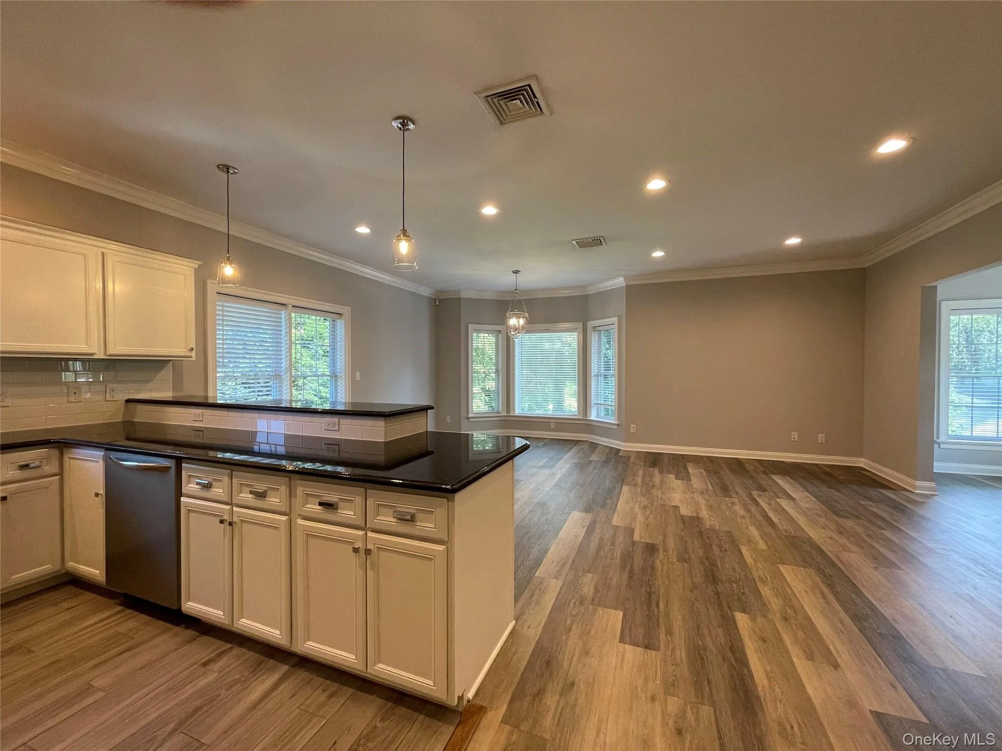 Kitchen with dishwasher, hanging light fixtures, and a peninsula Kitchen with dishwasher, hanging light fixtures, and a peninsula