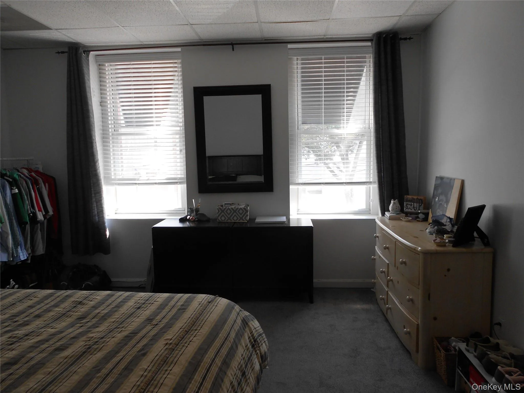 Bedroom with dark colored carpet and baseboards Bedroom with dark colored carpet and baseboards