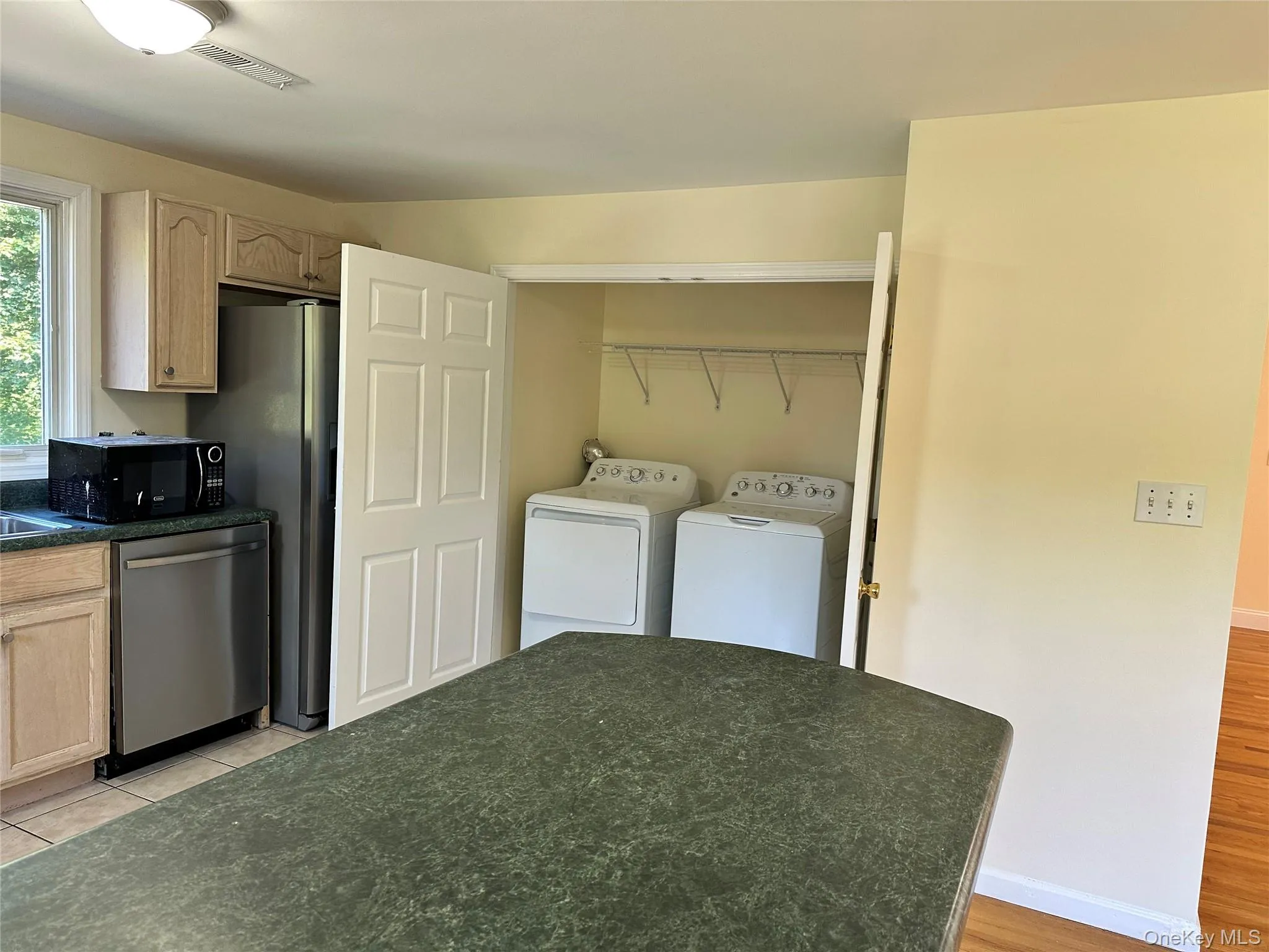 Laundry area in the kitchen featuring washer and clothes dryer Laundry area in the kitchen featuring washer and clothes dryer
