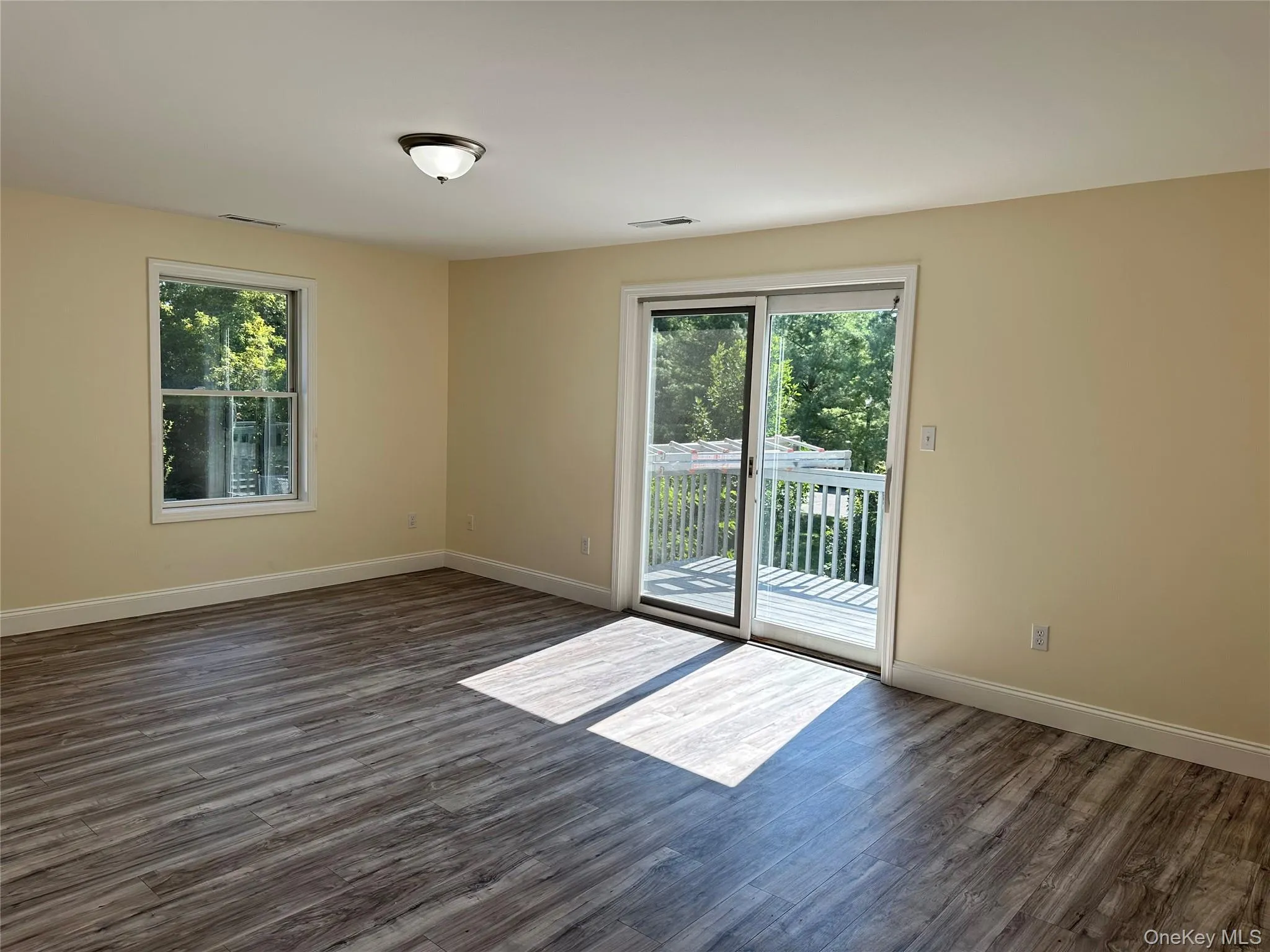 Large living room with sliding doors to deck Large living room with sliding doors to deck