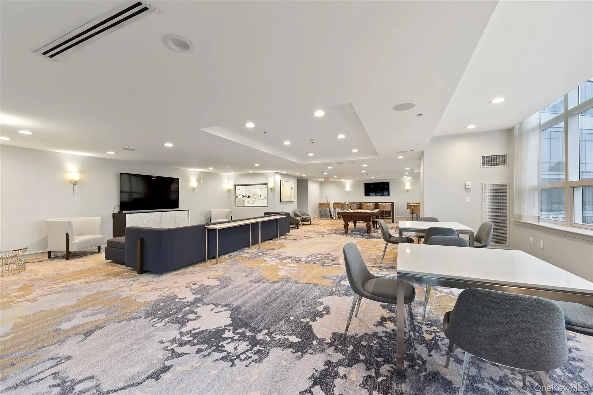 Dining area with recessed lighting, a raised ceiling, and light colored carpet Dining area with recessed lighting, a raised ceiling, and light colored carpet