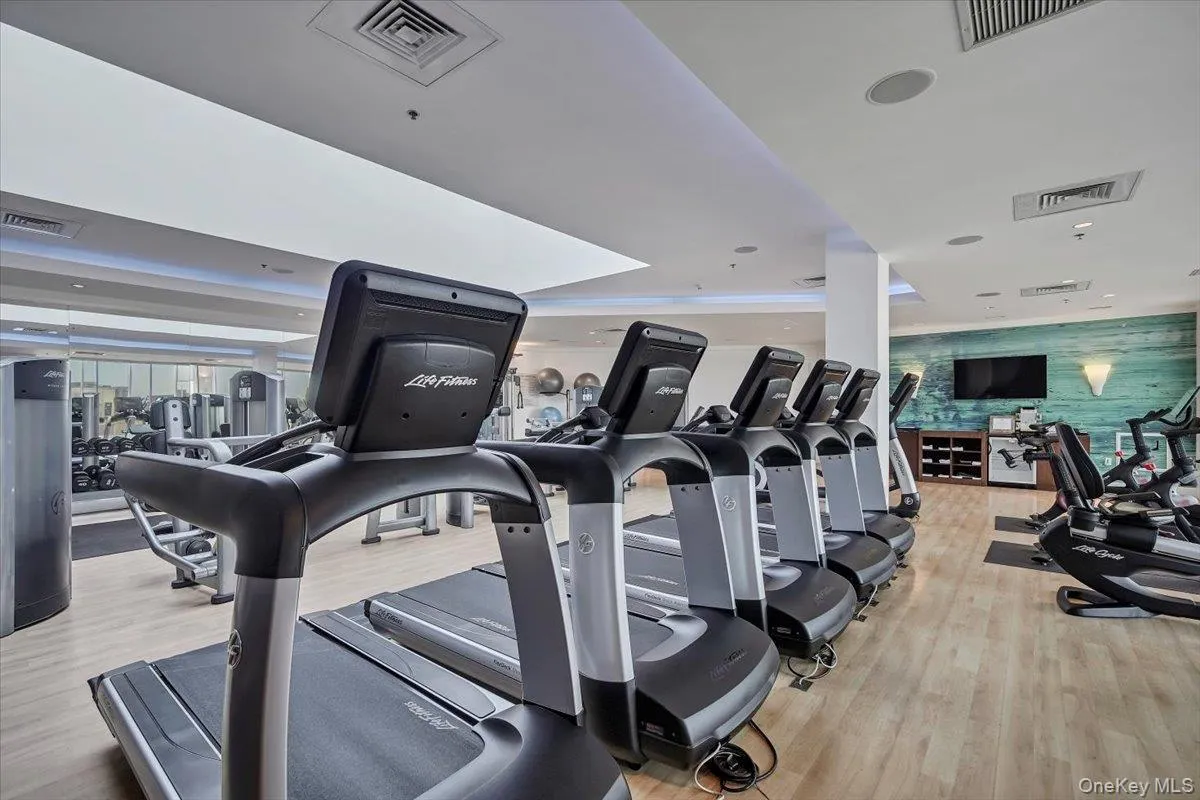 Exercise room with light wood-type flooring and recessed lighting Exercise room with light wood-type flooring and recessed lighting