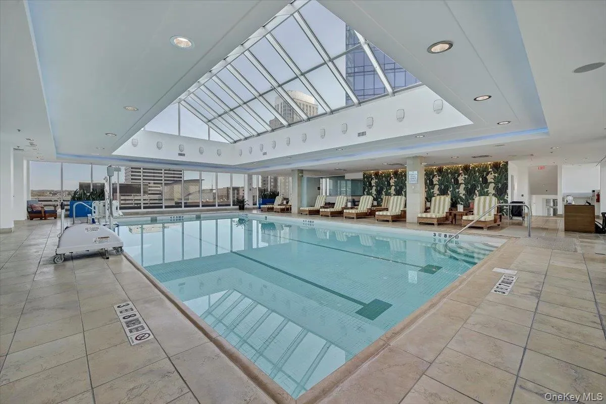 Indoor pool featuring a skylight Indoor pool featuring a skylight