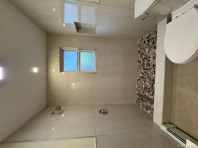 Bathroom featuring a stall shower, and recessed lighting Bathroom featuring a stall shower, and recessed lighting