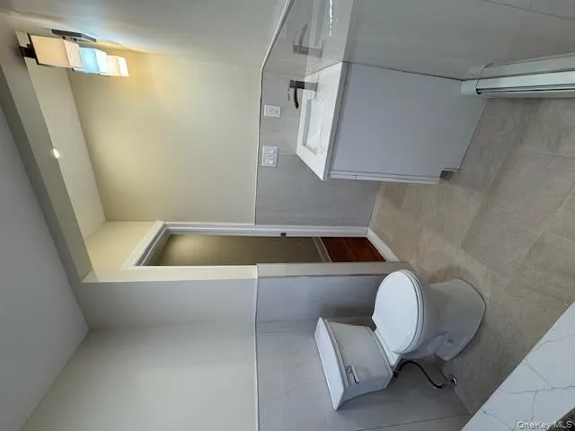 Full bath featuring vanity and a tile half wall Full bath featuring vanity and a tile half wall