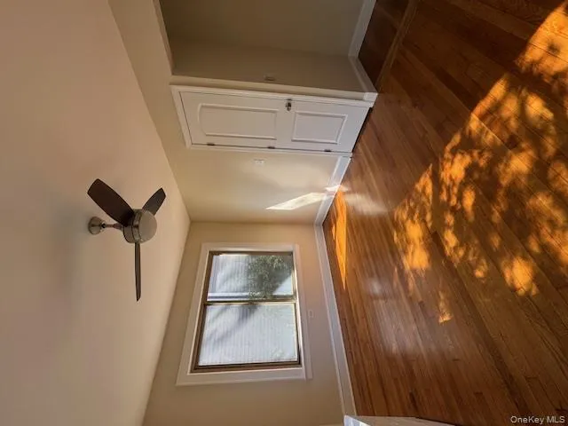 Unfurnished bedroom with dark wood-style flooring and ceiling fan Unfurnished bedroom with dark wood-style flooring and ceiling fan