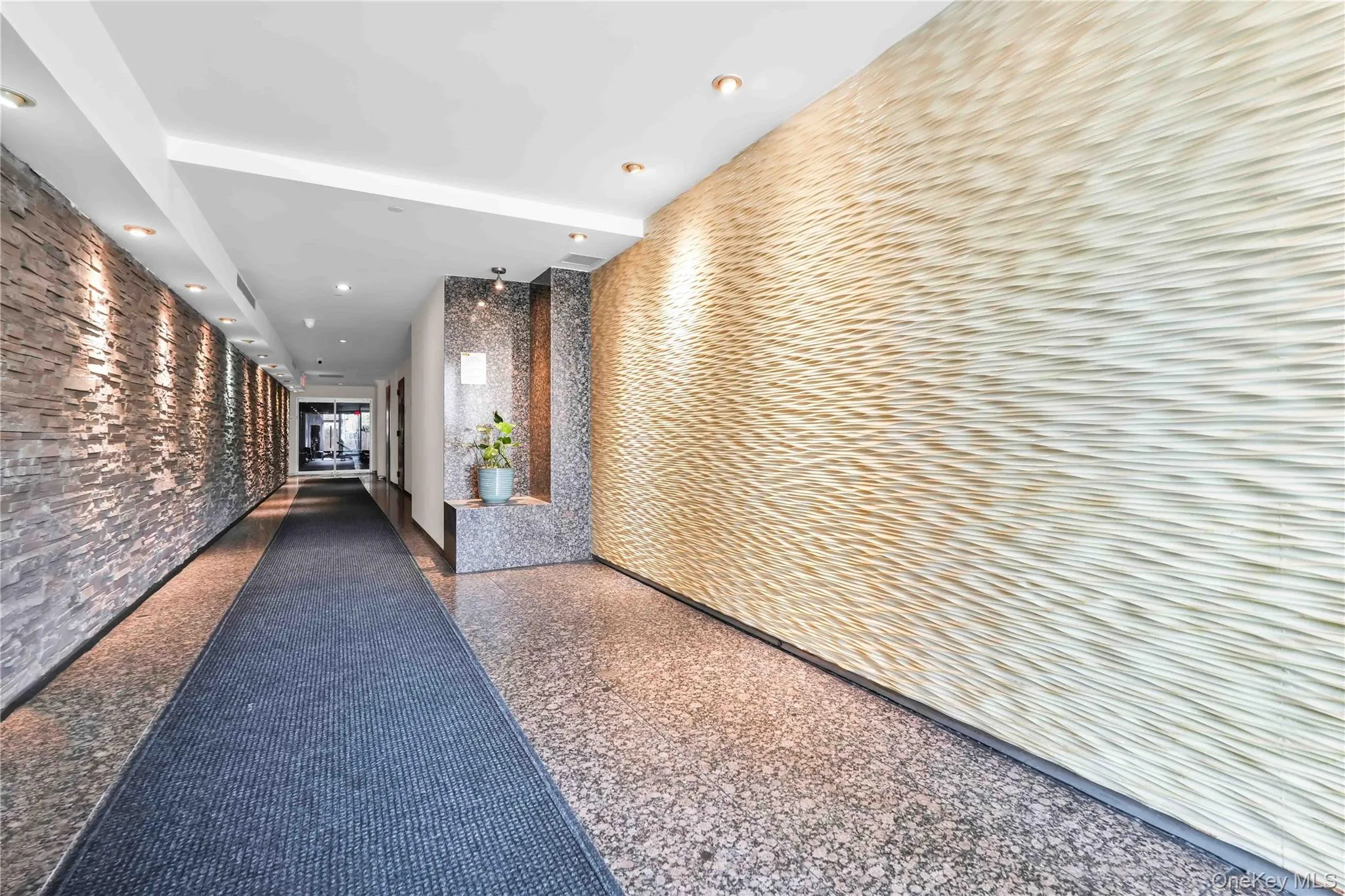 Corridor featuring recessed lighting and light aggregate flooring Corridor featuring recessed lighting and light aggregate flooring