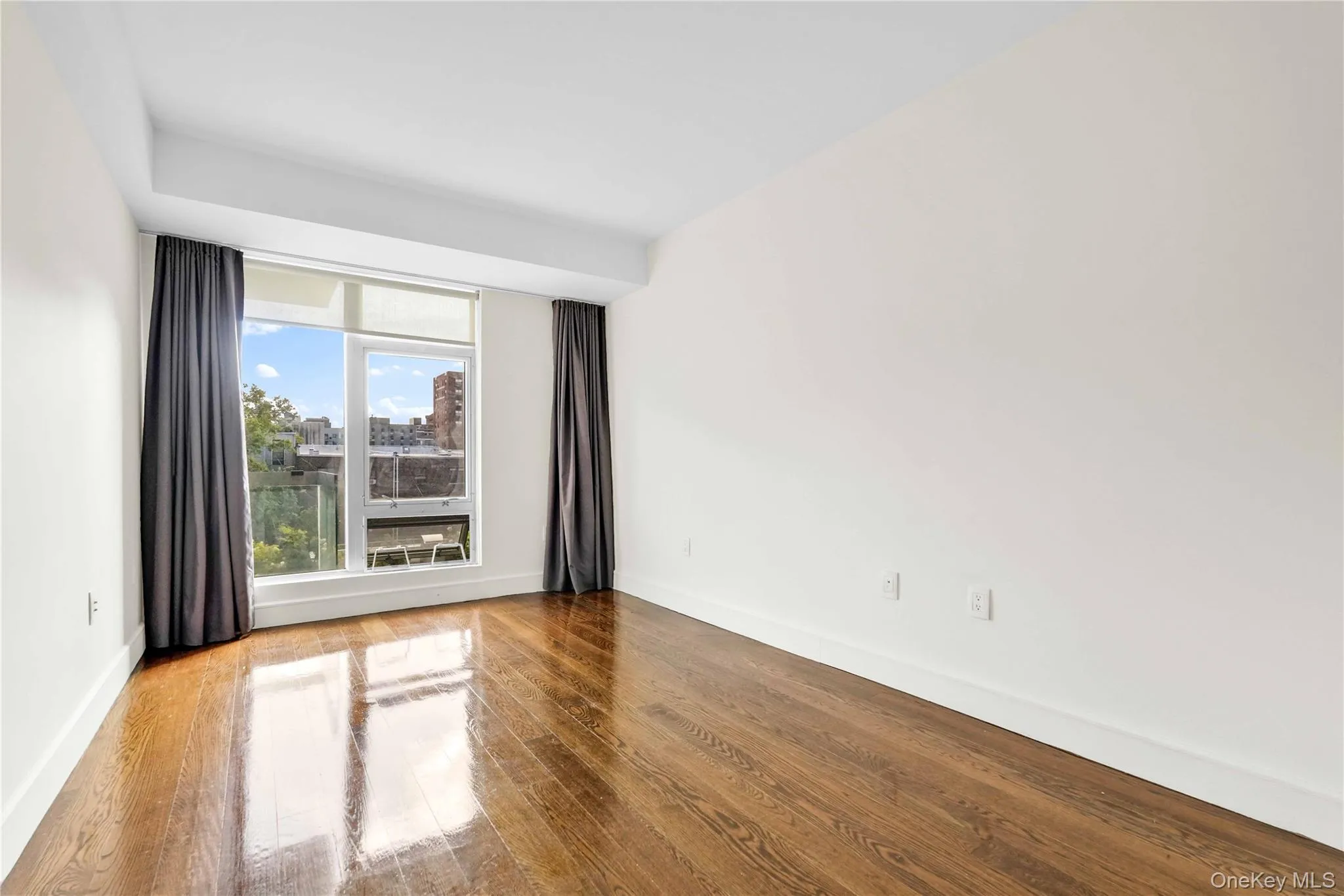 Spare room featuring wood finished floors Spare room featuring wood finished floors