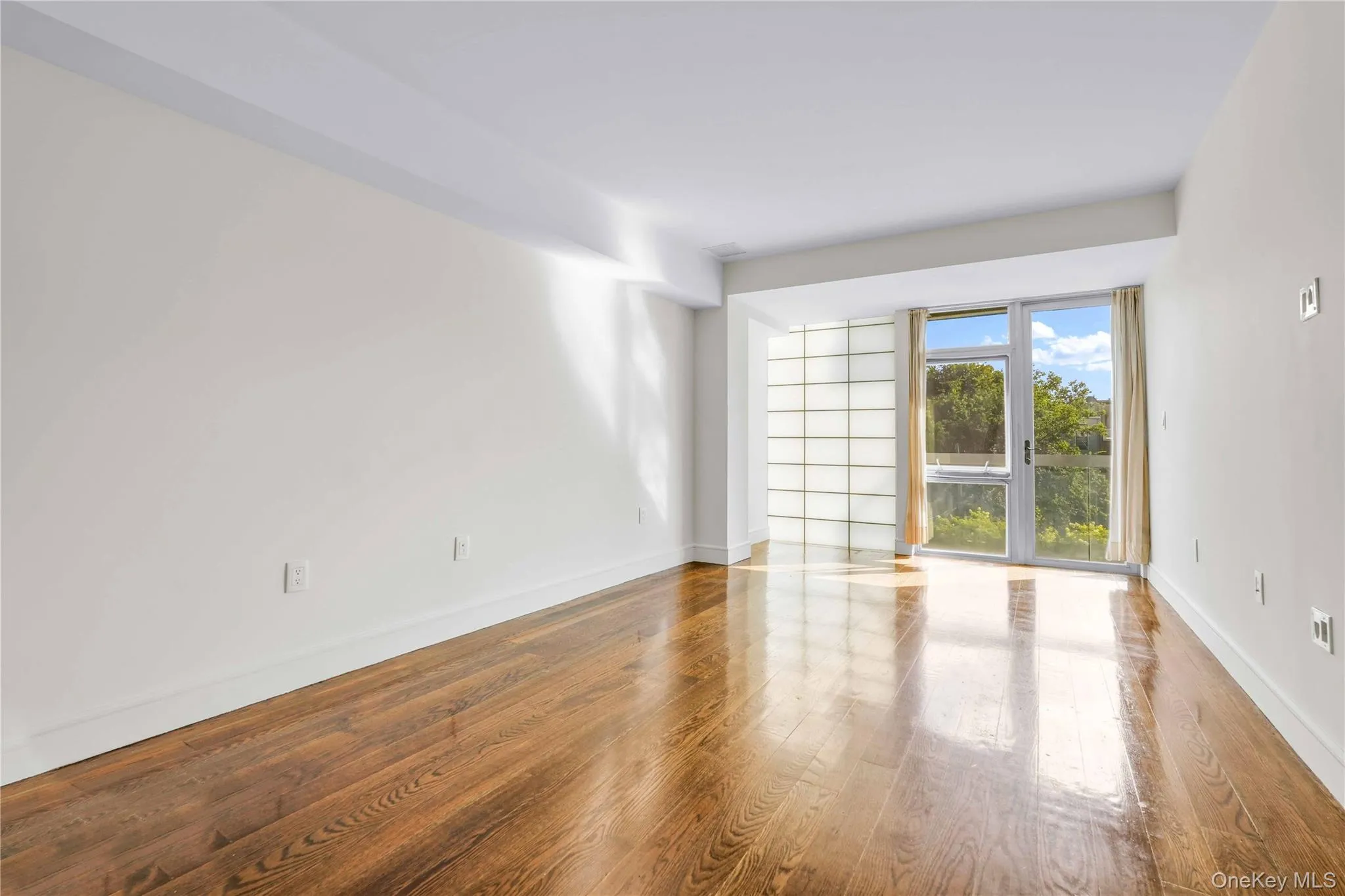 Empty room featuring wood finished floors and baseboards Empty room featuring wood finished floors and baseboards