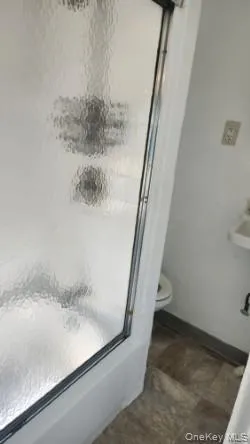 Full bathroom with a shower stall and toilet Full bathroom with a shower stall and toilet