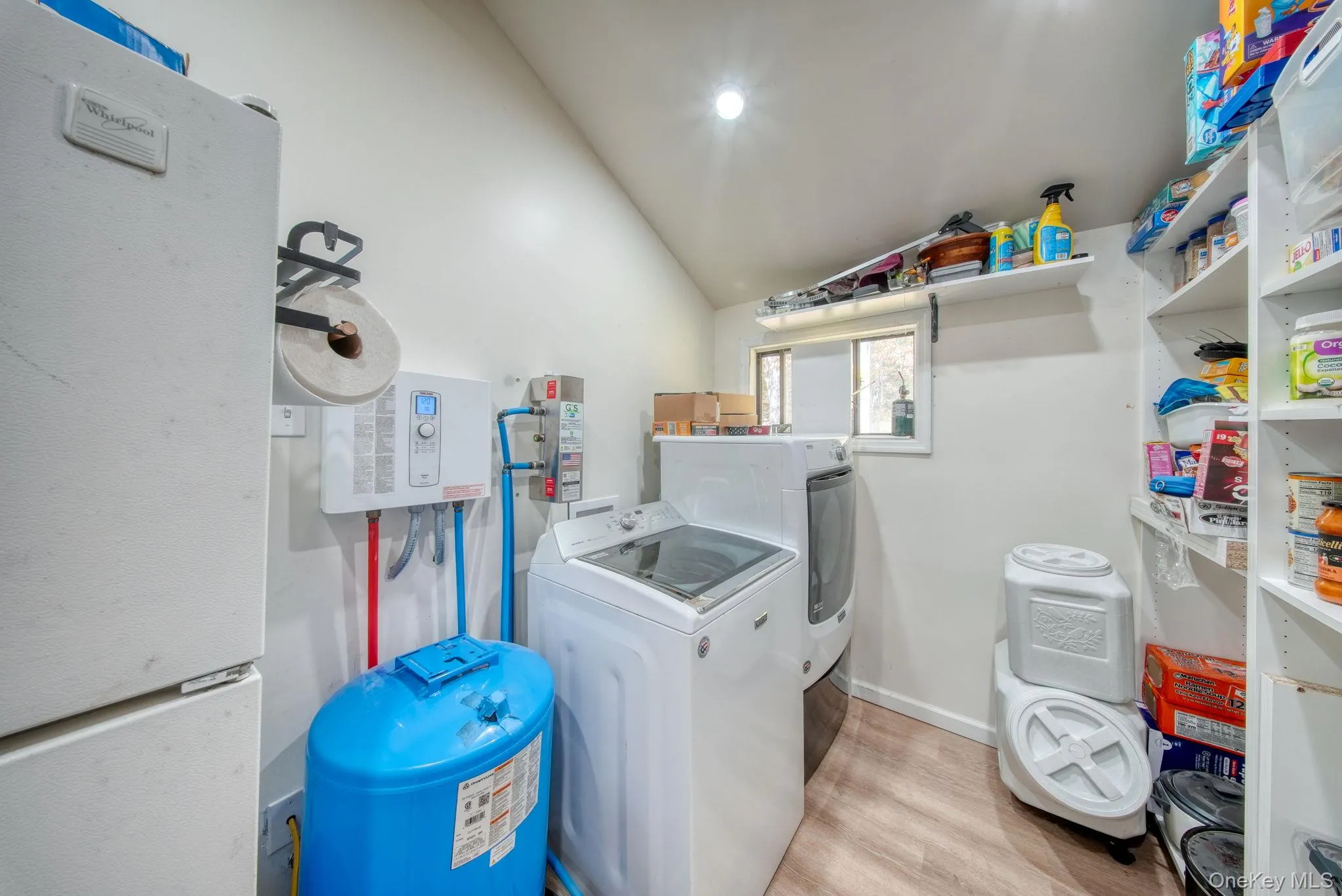 Laundry room with light wood-type flooring and washer and dryer Laundry room with light wood-type flooring and washer and dryer