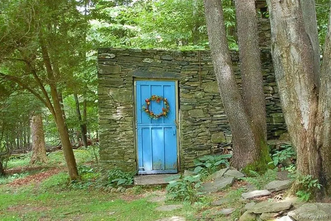 View of exterior entry featuring stone siding View of exterior entry featuring stone siding