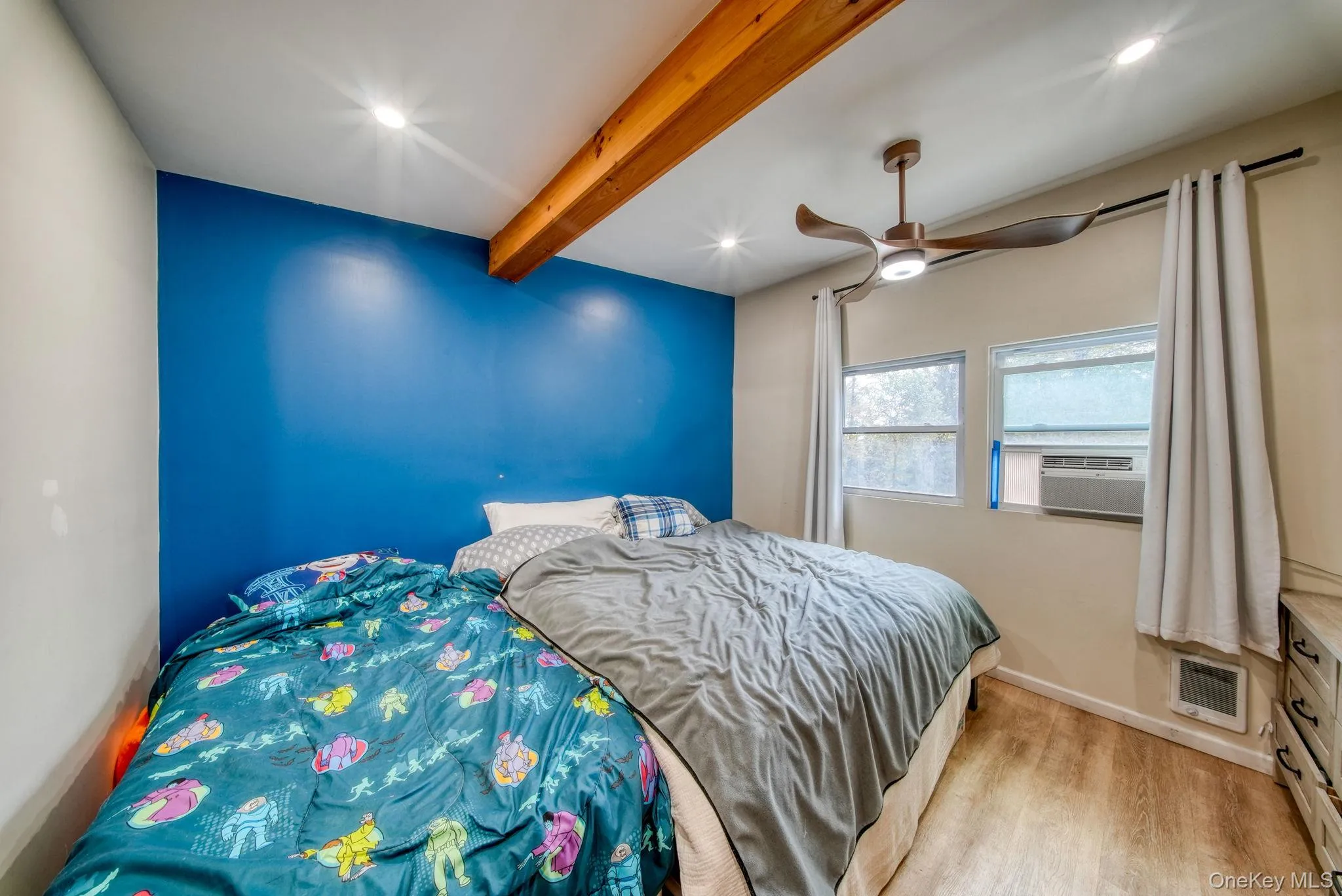 Bedroom featuring beamed ceiling, light wood-type flooring, ceiling fan, recessed lighting, and cooling unit Bedroom featuring beamed ceiling, light wood-type flooring, ceiling fan, recessed lighting, and cooling unit