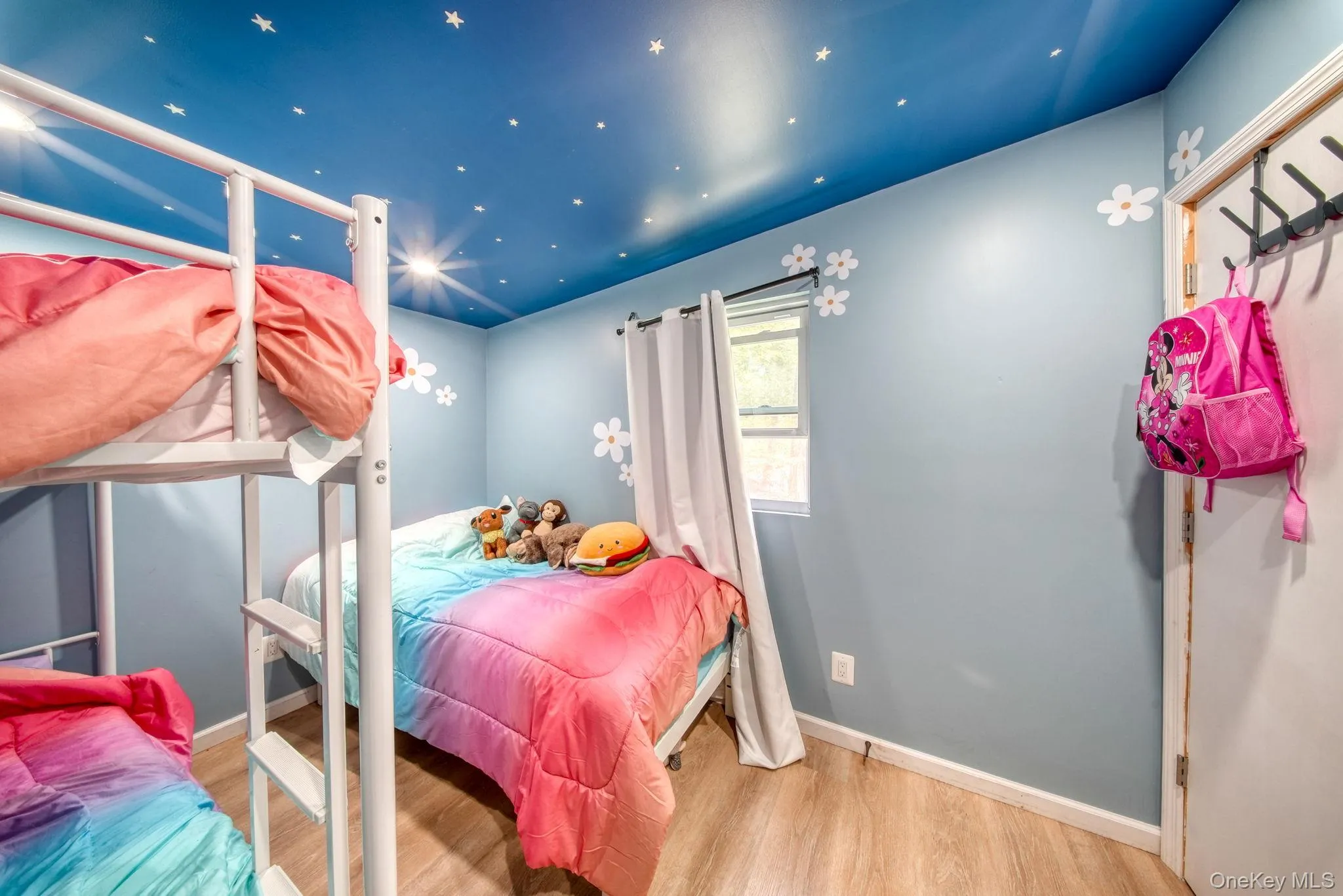 Bedroom featuring light wood finished floors and baseboards Bedroom featuring light wood finished floors and baseboards