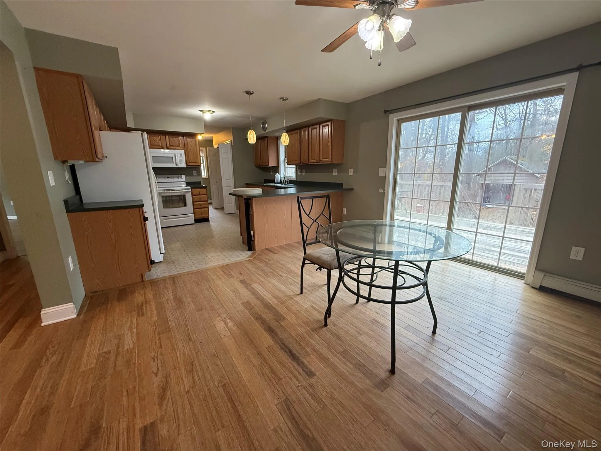 Dining area featuring ceiling fan and light wood-type flooring Dining area featuring ceiling fan and light wood-type flooring