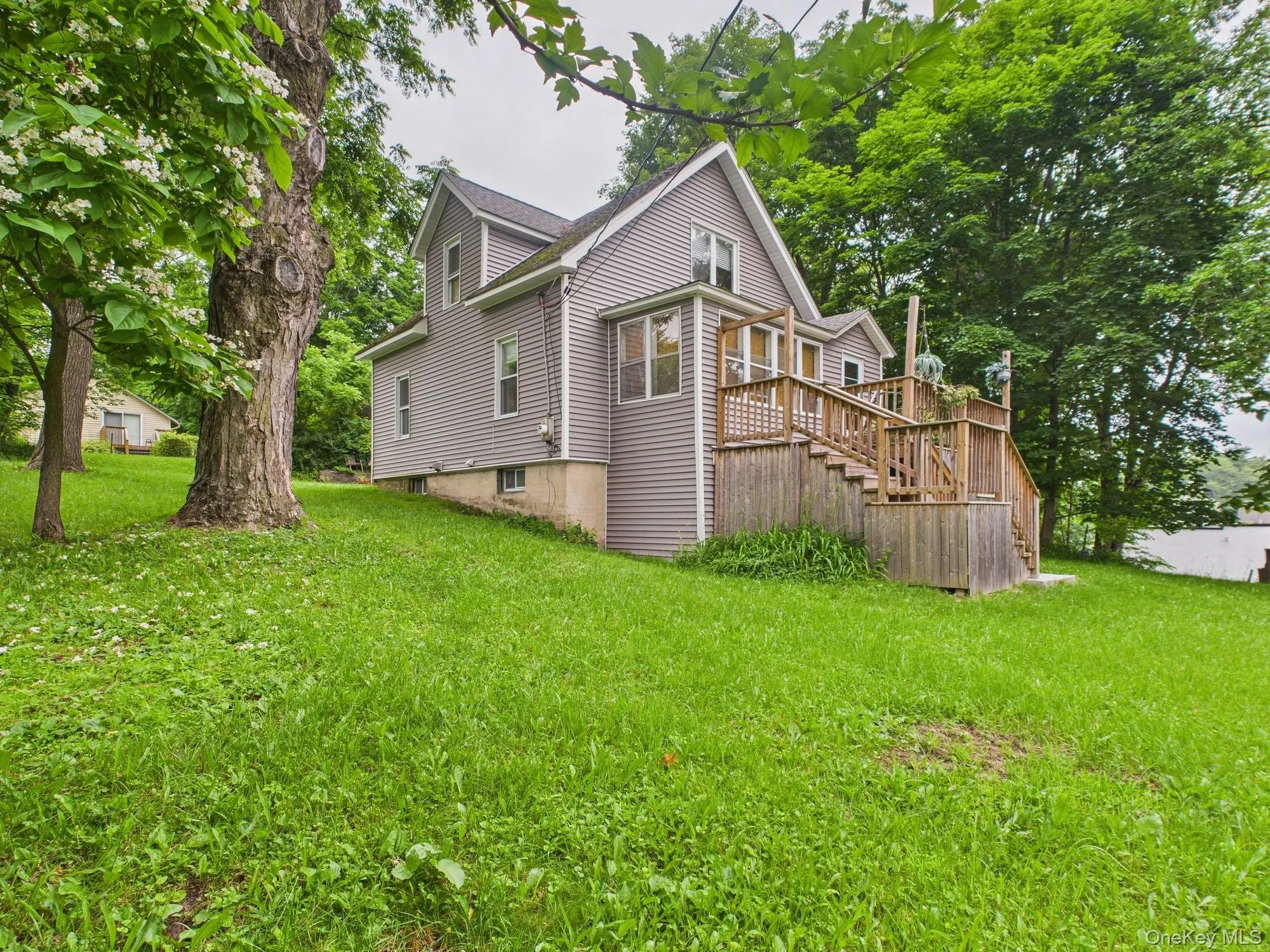 View of side of property featuring stairway, a yard, and a deck View of side of property featuring stairway, a yard, and a deck