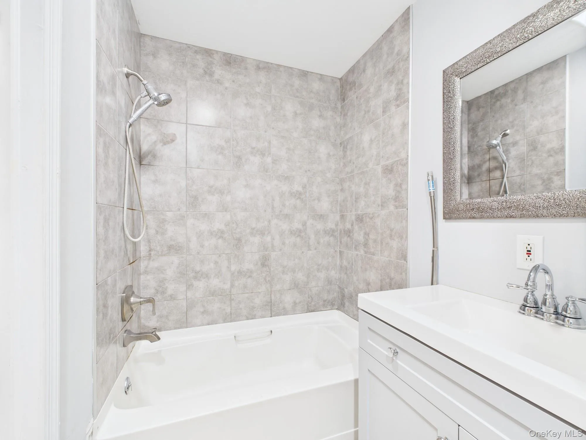 Full bathroom featuring vanity and shower / tub combination Full bathroom featuring vanity and shower / tub combination