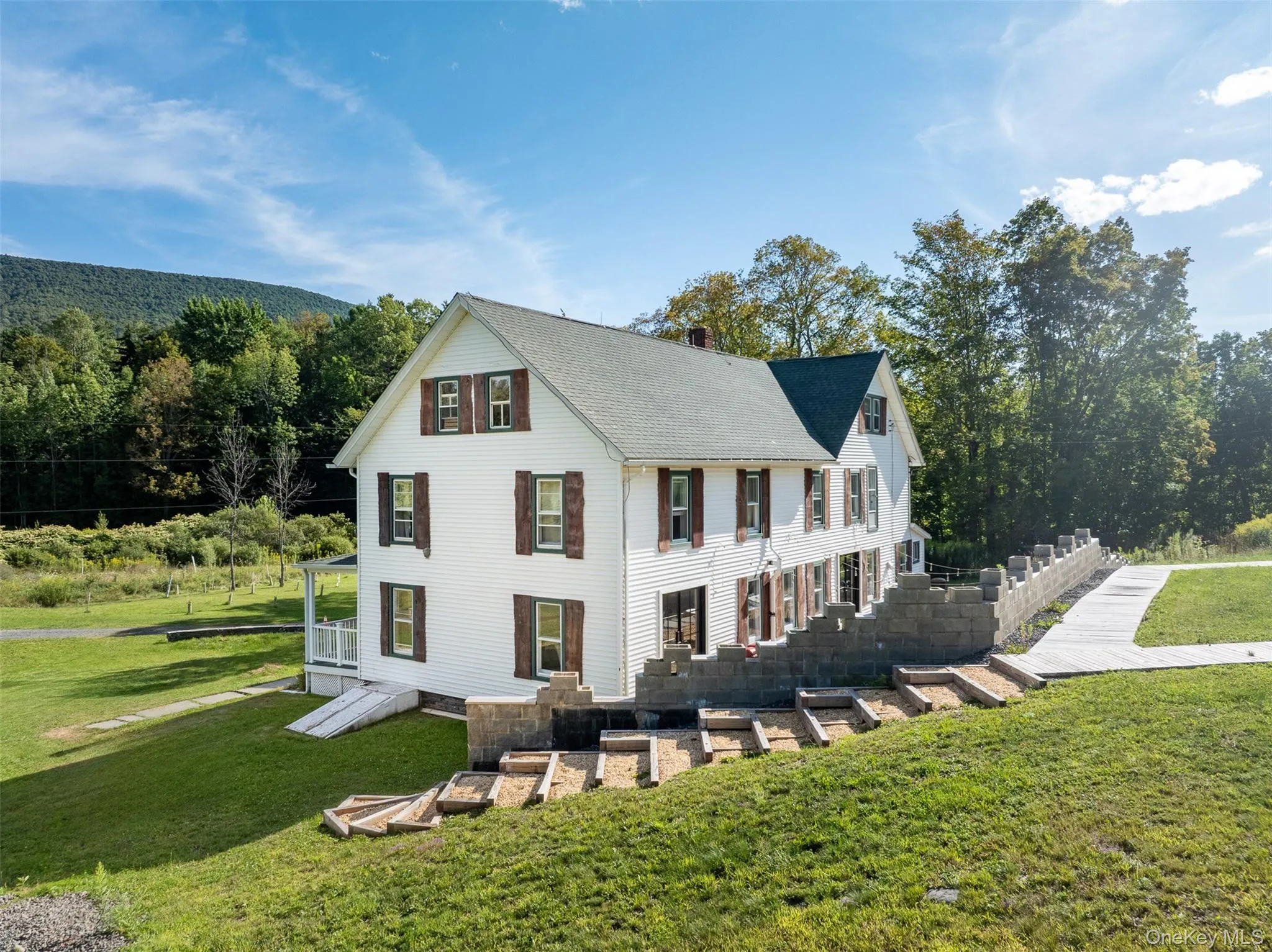 View of front facade featuring a front yard and a chimney View of front facade featuring a front yard and a chimney