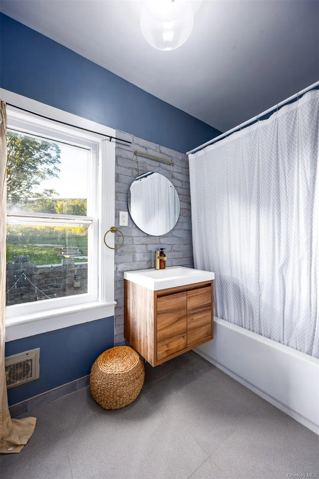 Full bath with vanity, shower / tub combo, and tile patterned floors Full bath with vanity, shower / tub combo, and tile patterned floors