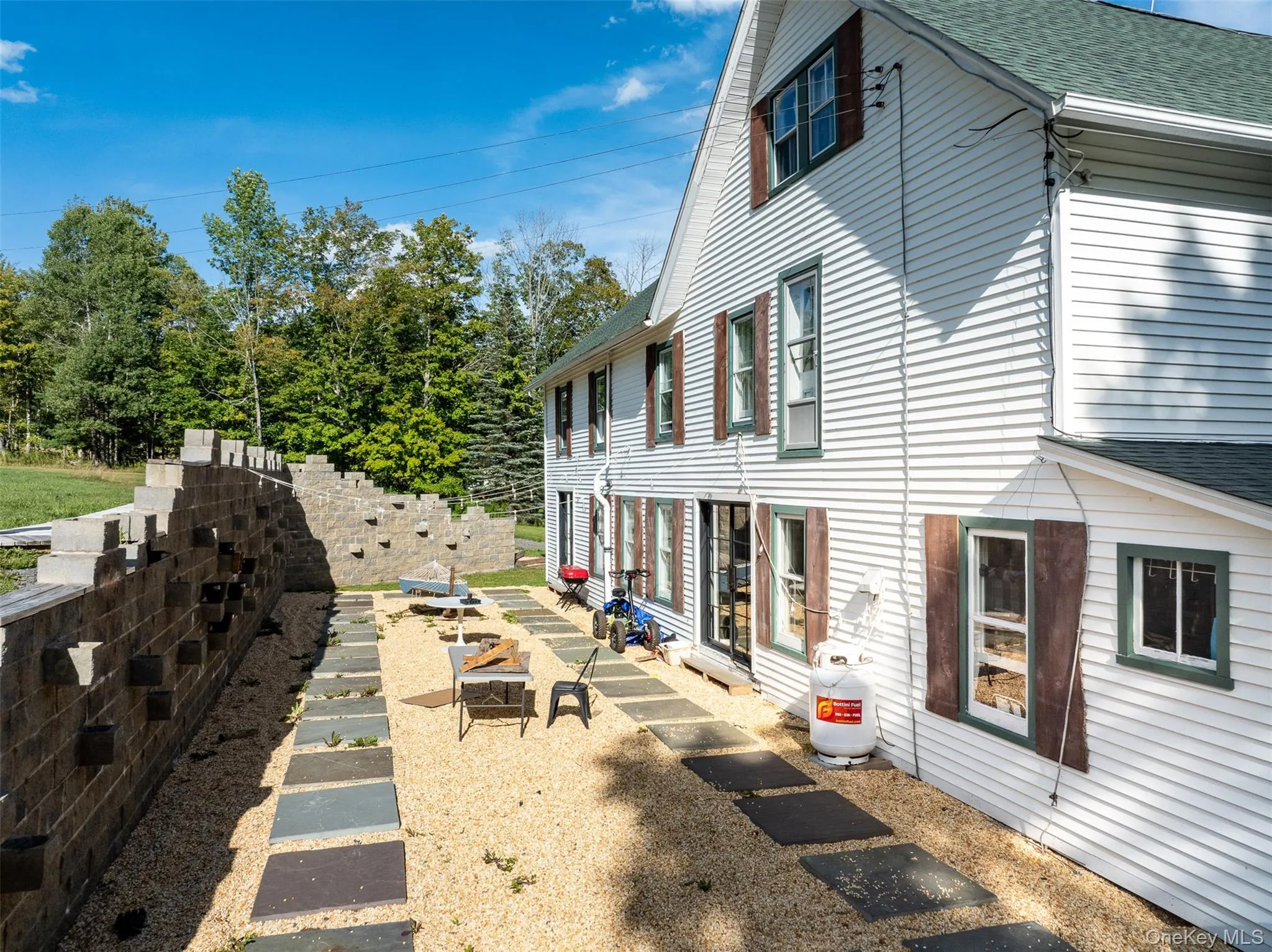 View of side of property featuring a shingled roof View of side of property featuring a shingled roof