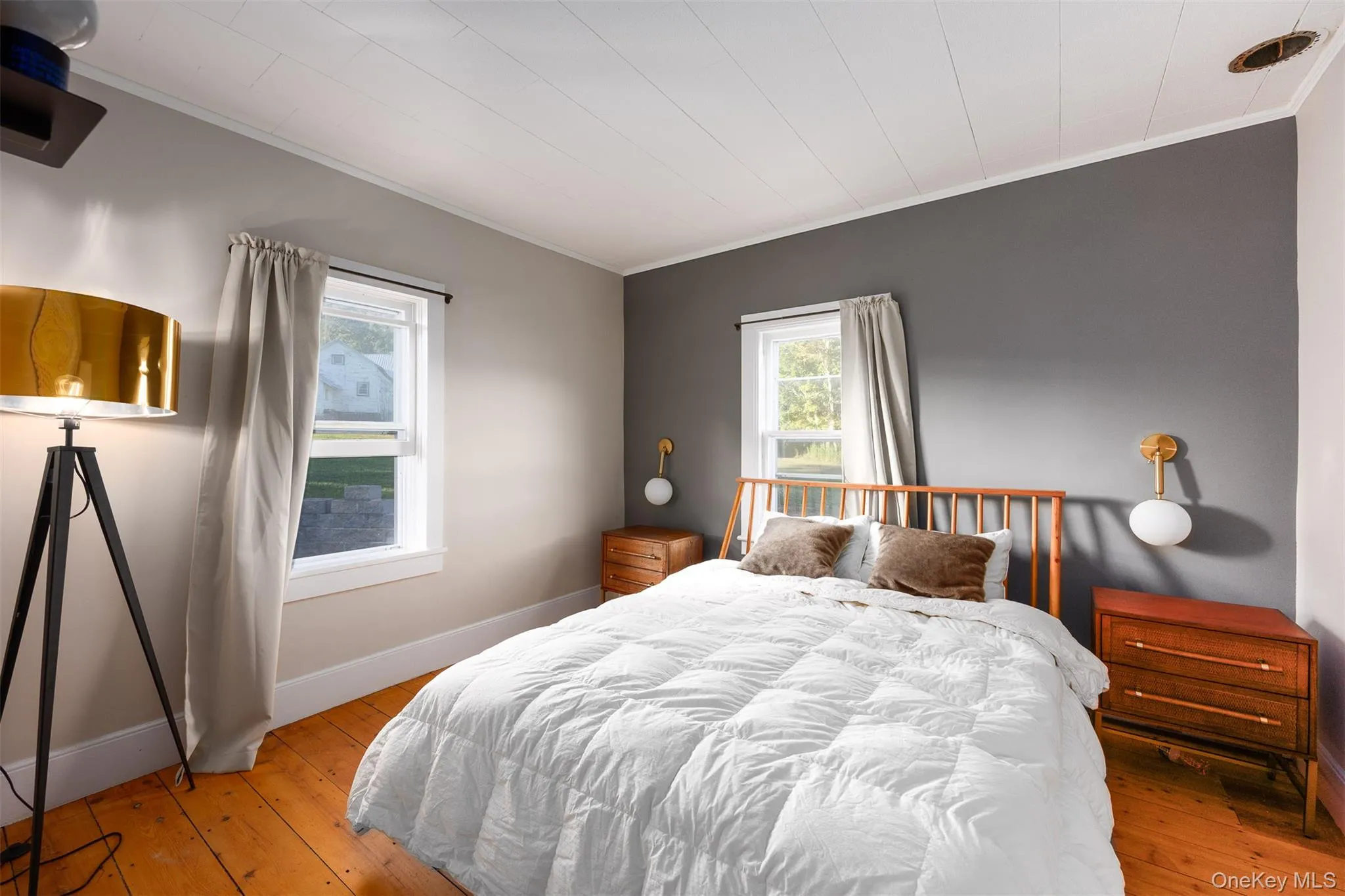 Bedroom featuring crown molding and light wood-type flooring Bedroom featuring crown molding and light wood-type flooring