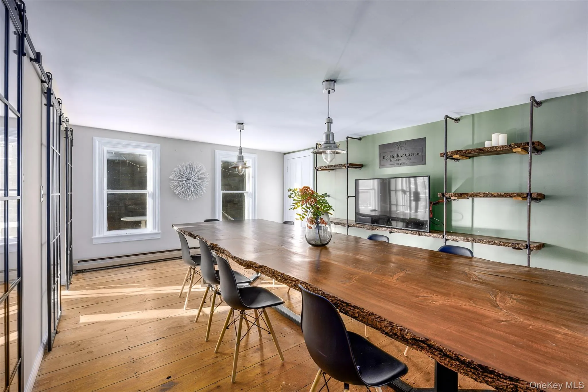Dining room featuring light wood-type flooring and a baseboard heating unit Dining room featuring light wood-type flooring and a baseboard heating unit