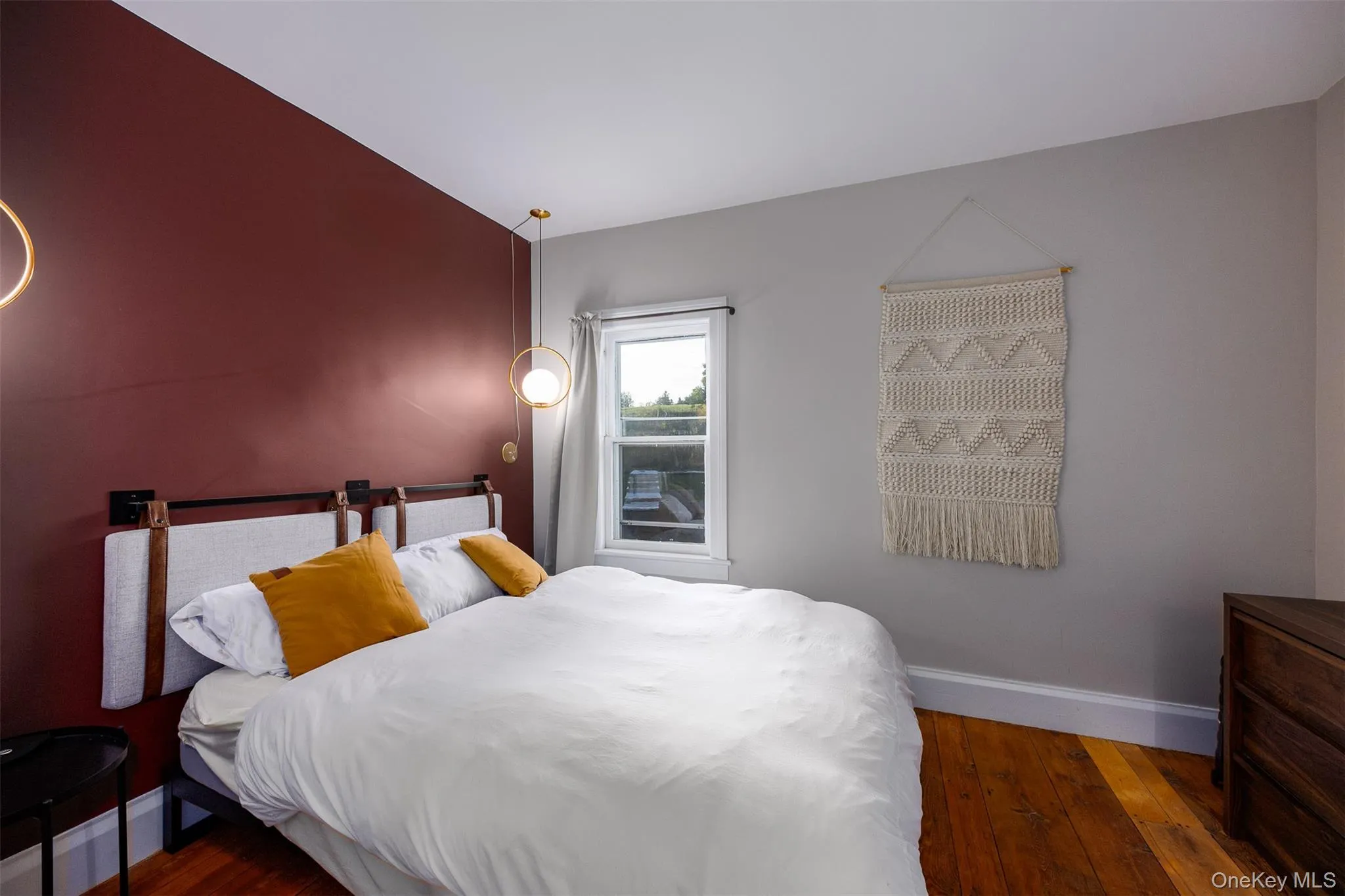 Bedroom featuring hardwood / wood-style flooring and baseboards Bedroom featuring hardwood / wood-style flooring and baseboards