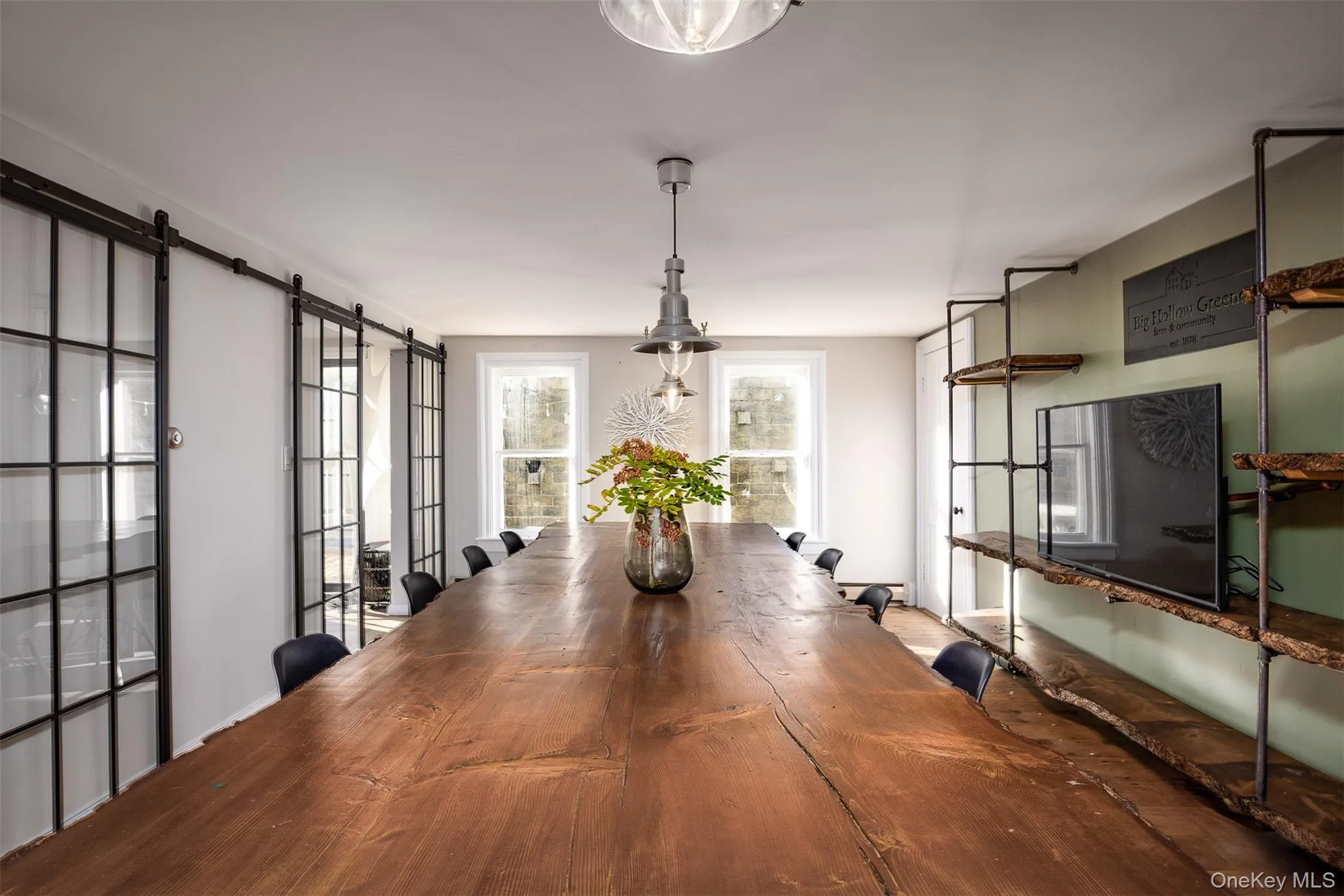 Dining room featuring a barn door and baseboards Dining room featuring a barn door and baseboards