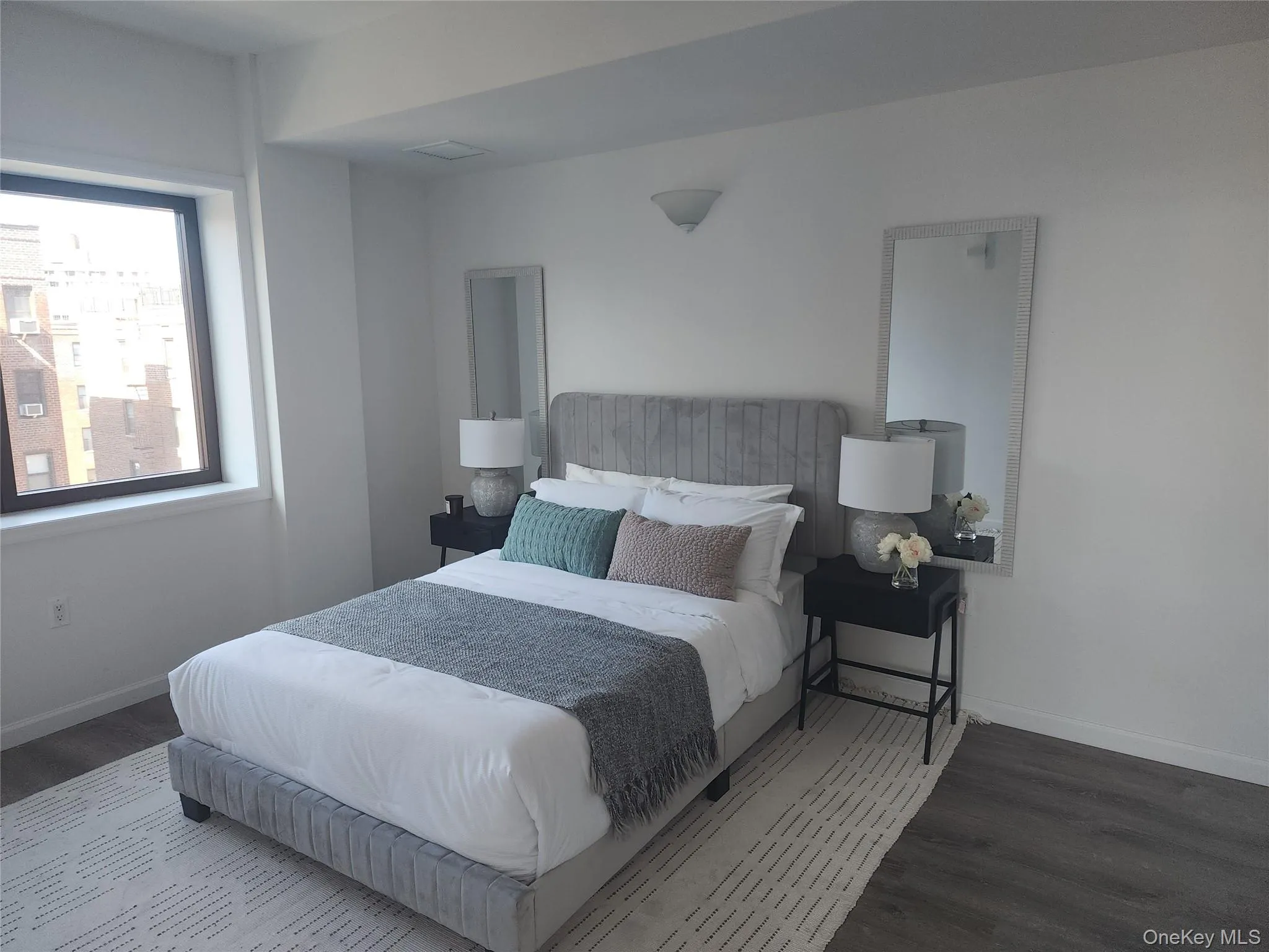 Bedroom with wood finished floors and baseboards Bedroom with wood finished floors and baseboards